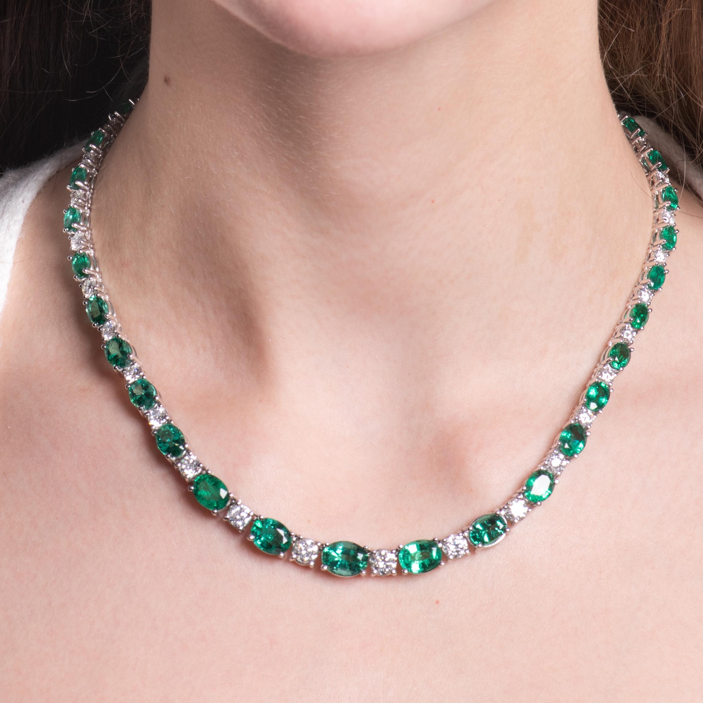 This exquisite emerald necklace has a 25.68ct total weight in oval cut emeralds and 8.66ct total weight in round diamonds. The emerald stones have a medium to strong saturation of bright lime green color, and they are especially clean for emeralds.