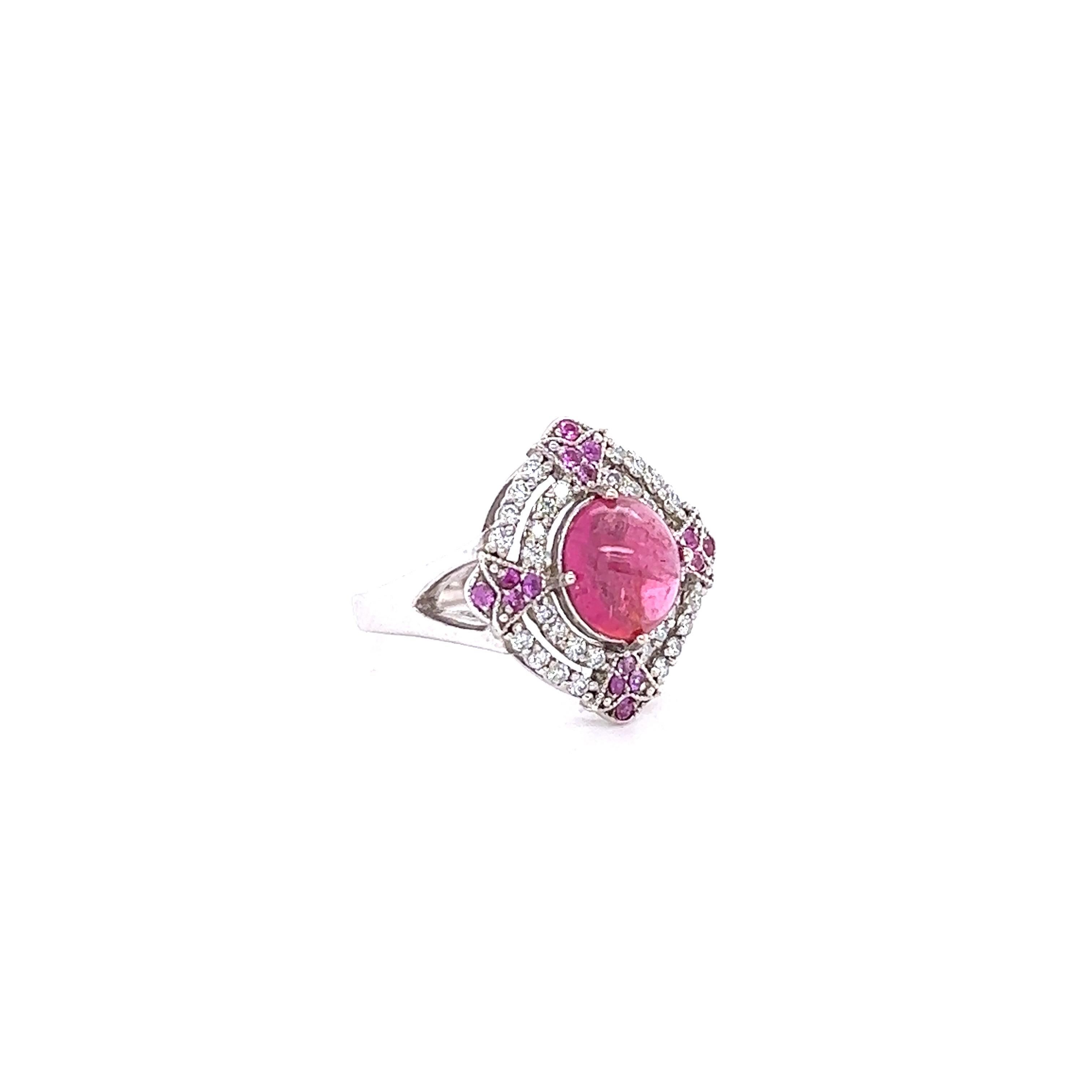 This ring has a Cabochon Pink Tourmaline that weighs 2.08 Carats and measures at approximately 8 mm x 6 mm. There are 32 Round Cut Diamonds that weigh 0.32 Carats. (Clarity: VS2, Color: H) and 16 Round Cut Pink Sapphires that weigh 0.17 carats.  The