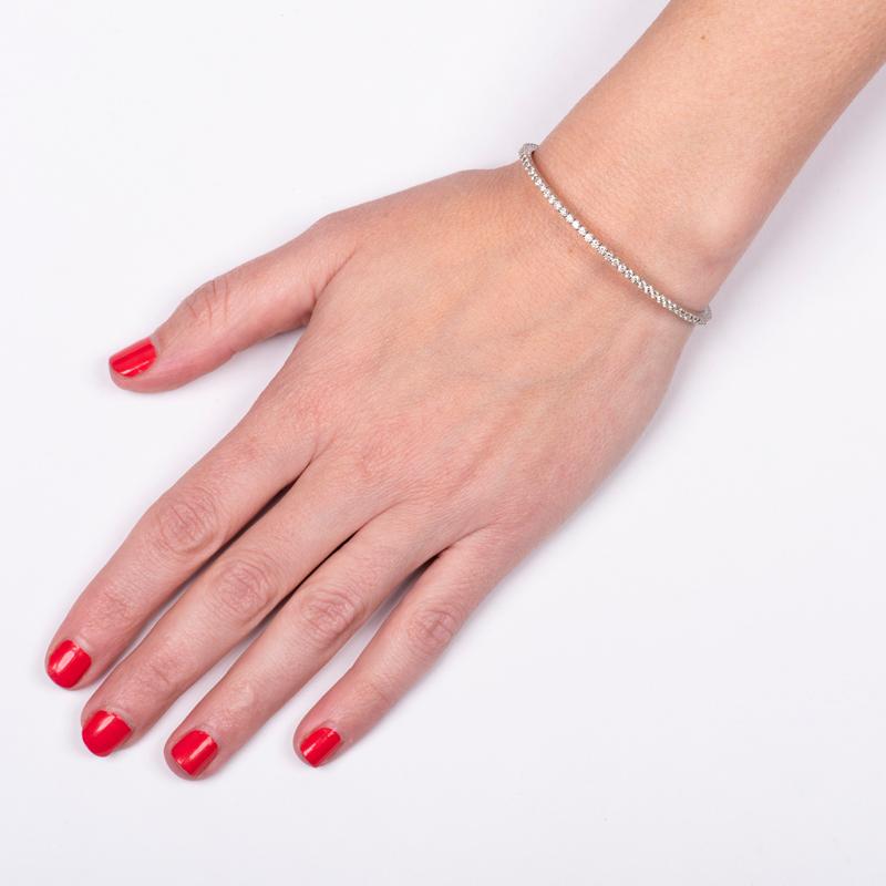 This flexible diamond bangle bracelet features 2.57 carat total weight in natural round diamonds set in 14 karat white gold. Push lock clasp. Wear alone or pair with your other favorite bracelets for a unique look. This will fit up to a 6.5