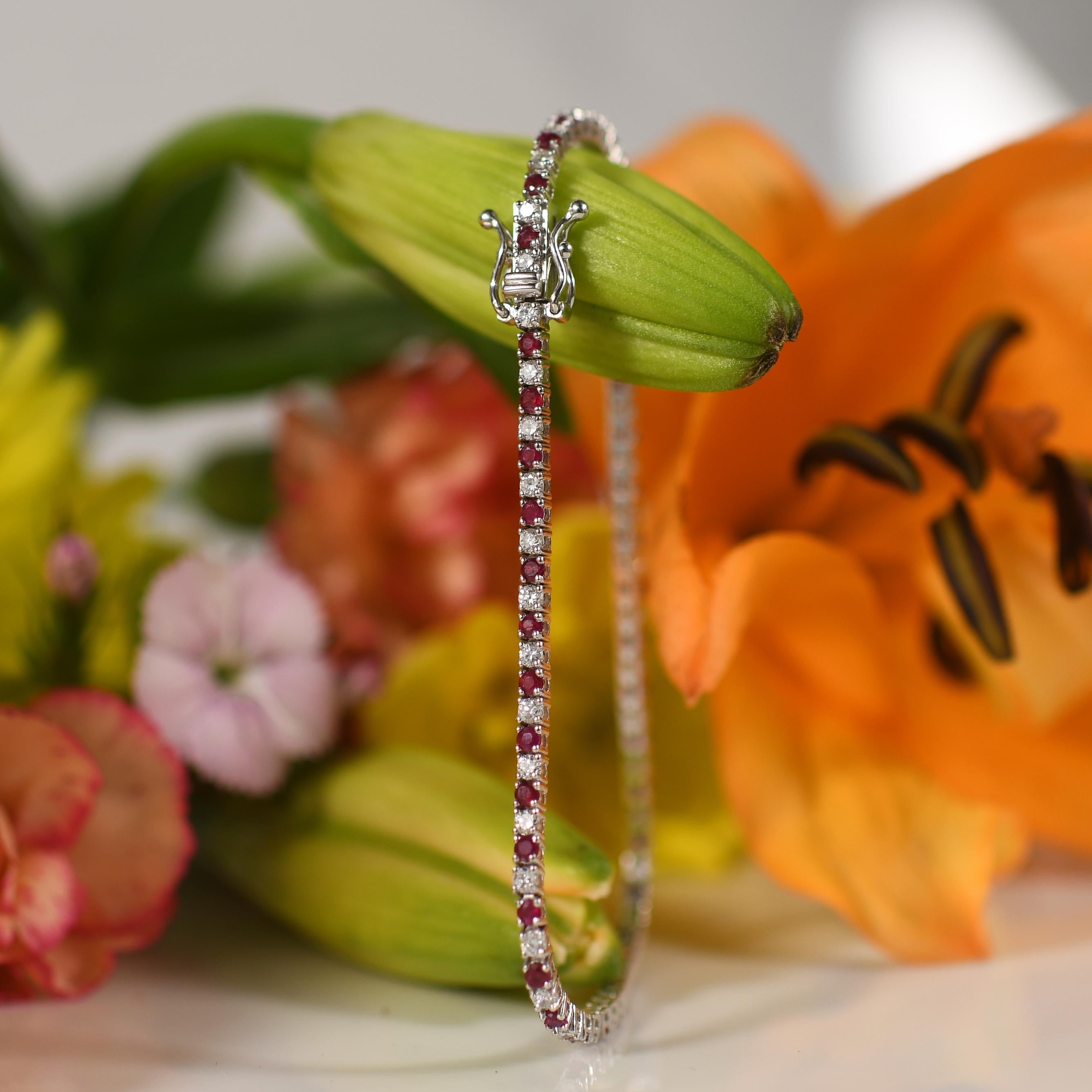 Radiating with timeless allure, this stunning bracelet boasts a total weight of 2.57 carats, adorned with radiant rubies and dazzling diamonds. Crafted from gleaming 14K white gold, its intricate design showcases the fiery red hue of the rubies