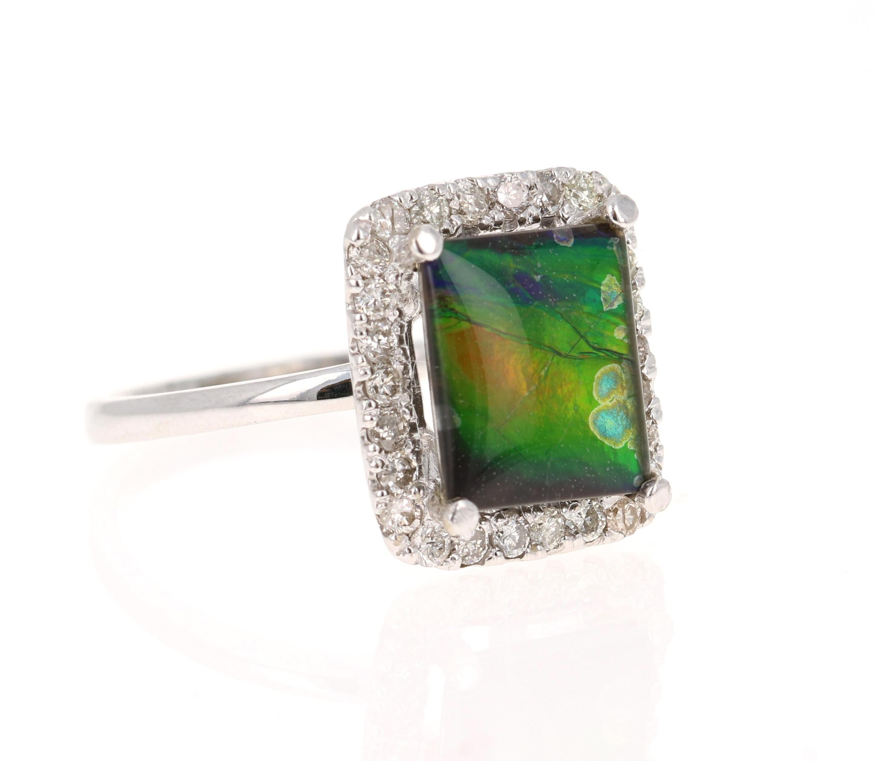 This unique ring has a Emerald Cut 2.15 Carat Amolite.  '

Amolite is an Opal-like organic gemstone that is primarily found in the eastern slopes of the North American Rocky Mountains. The Amolite has hues of green, blue, yellow & red and the lines