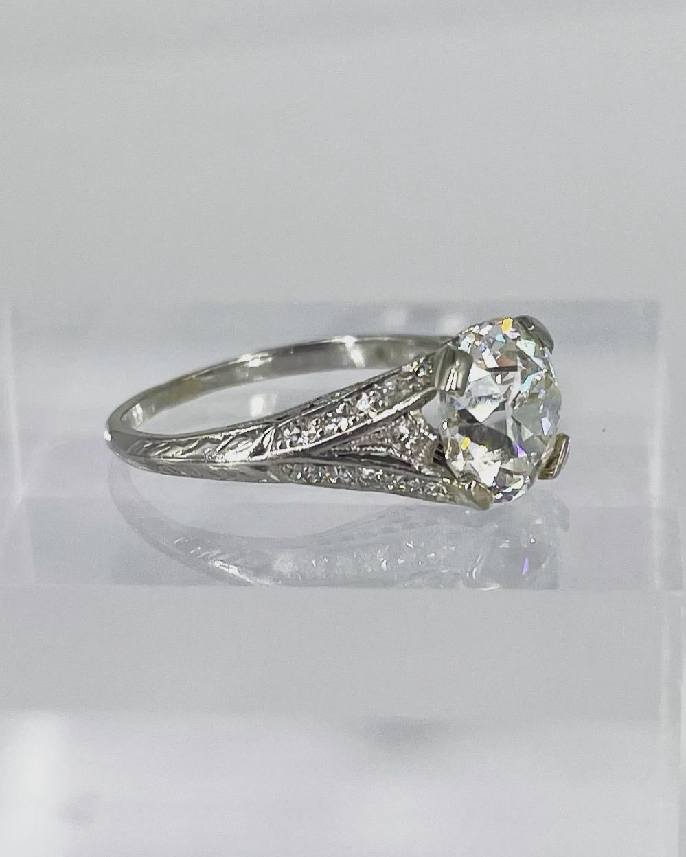 This exquisitely detailed Art Deco engagement ring is a beautiful example of the intricate craftsmanship of the period. Featuring a 2.58 carat European cut diamond, it is very special to have an antique piece with the original diamond. The diamond