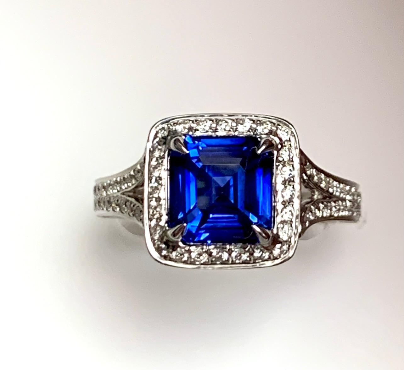 2.58 Carat Asscher cut Blue sapphire , heat ,  set in 18kw  Diamond cocktail ring , surronded with pave set diamonds and  pave set half way on the split shank and on the side of the ring and pave set diamonds in the gallery .