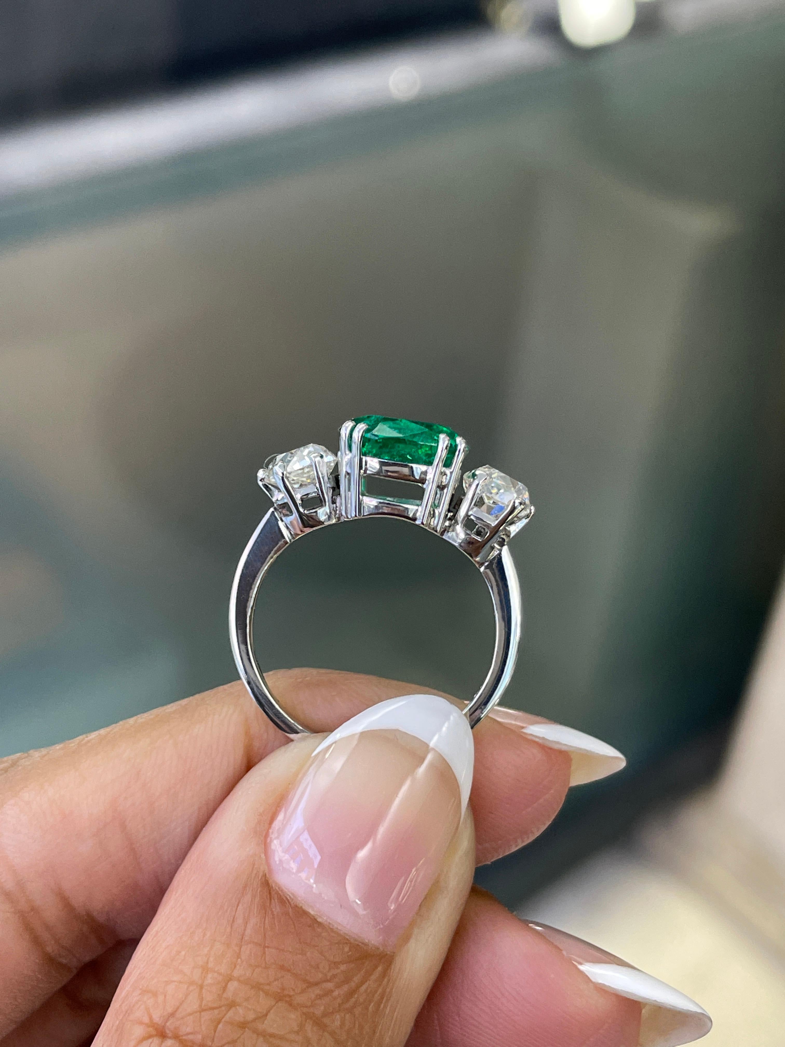 Antique Cushion Cut 2.58 Carat Colombian Emerald and Old Cut Diamond Three Stone Engagement Ring For Sale
