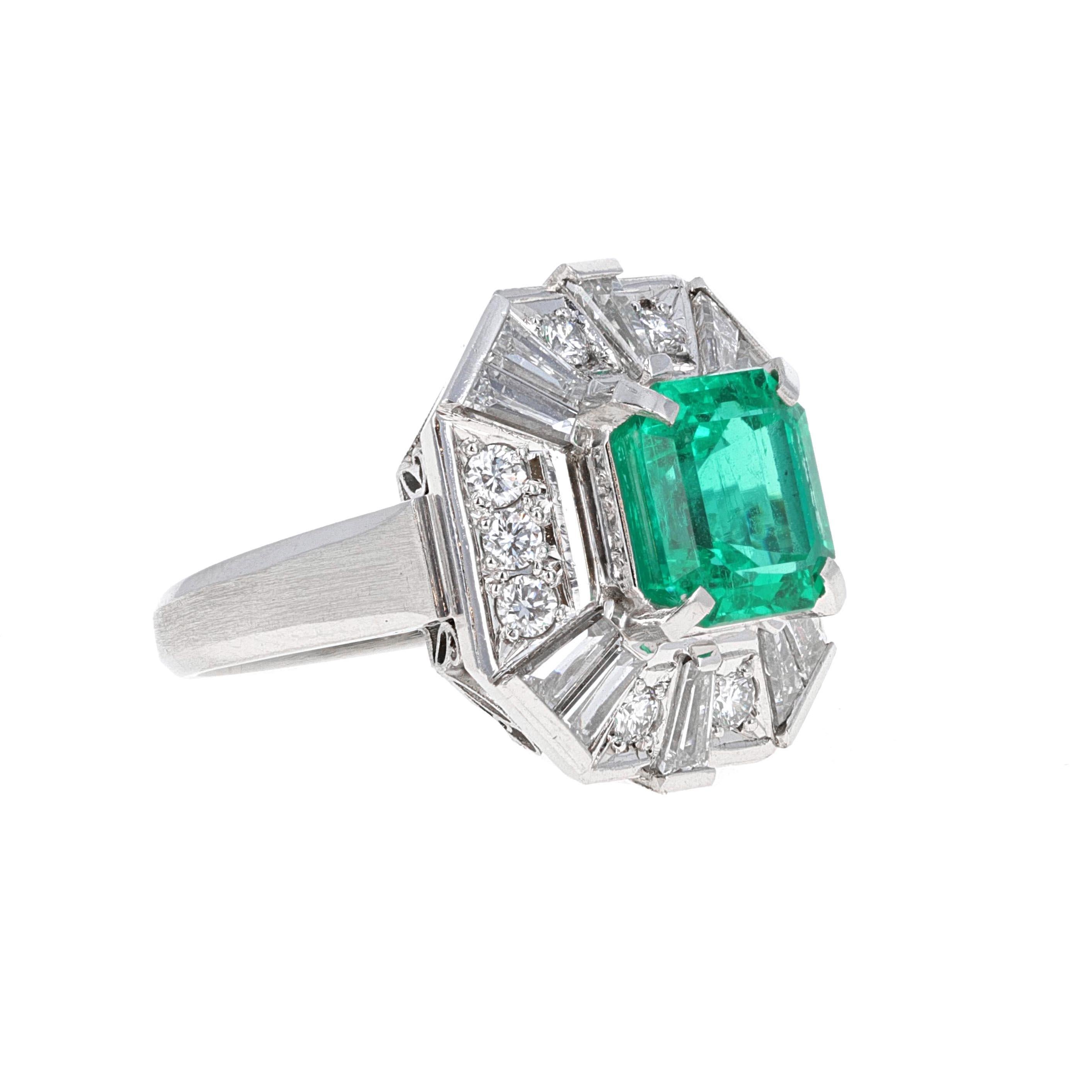 Beautifully hand made 2.58 carat Columbian Emerald and diamond cocktail ring. The emerald is an emerald cut and is surrounded by 20 white diamonds weighing a total of 1.17 carats. The diamonds in the mounting are round brilliants and baguettes.