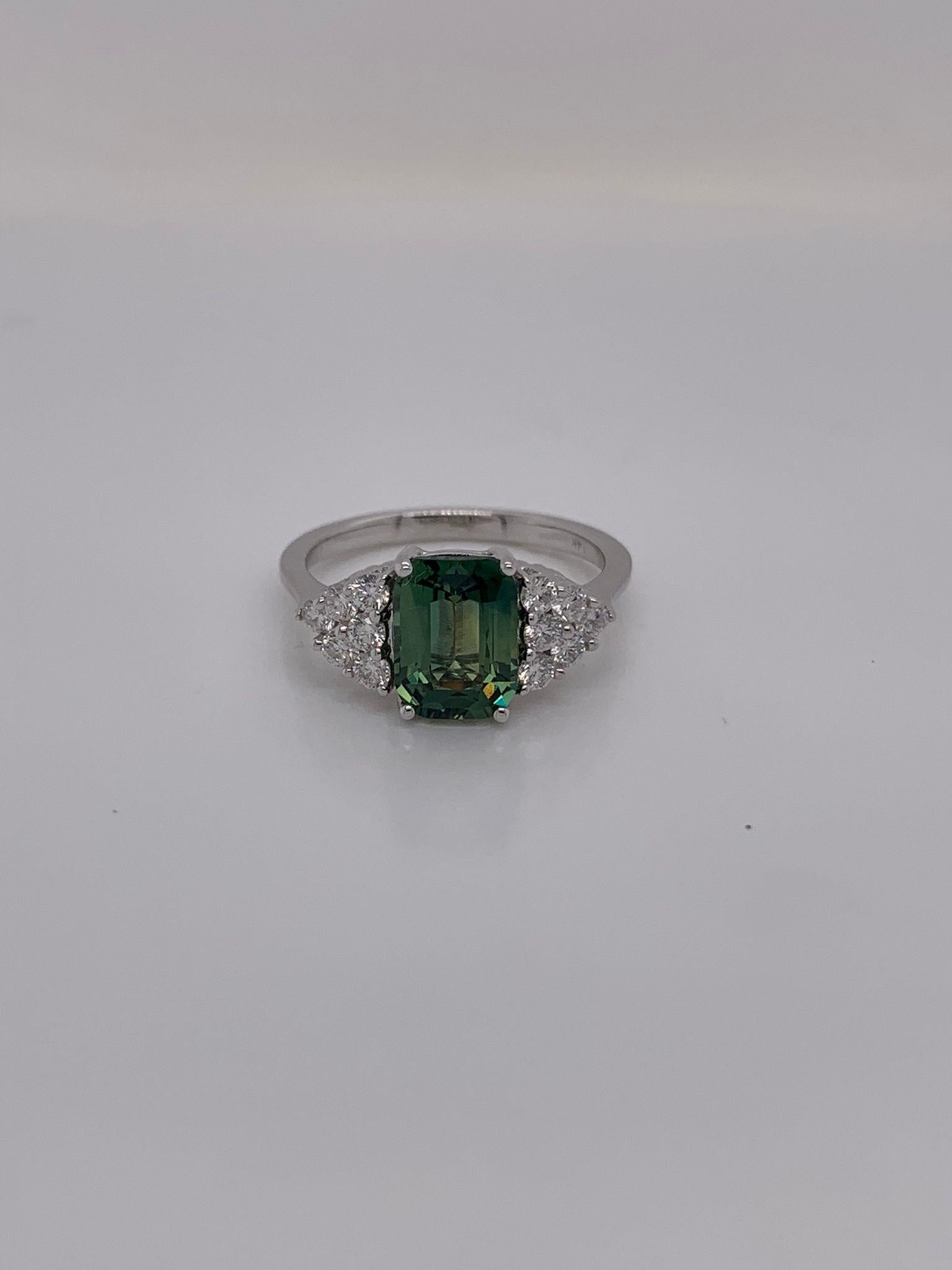 Cushion green sapphire weighing 2.58 cts.
Measuring (8.7x6.5) mm 
12 pieces of round diamonds weighing .42 cts.
Set in 14K white gold ring