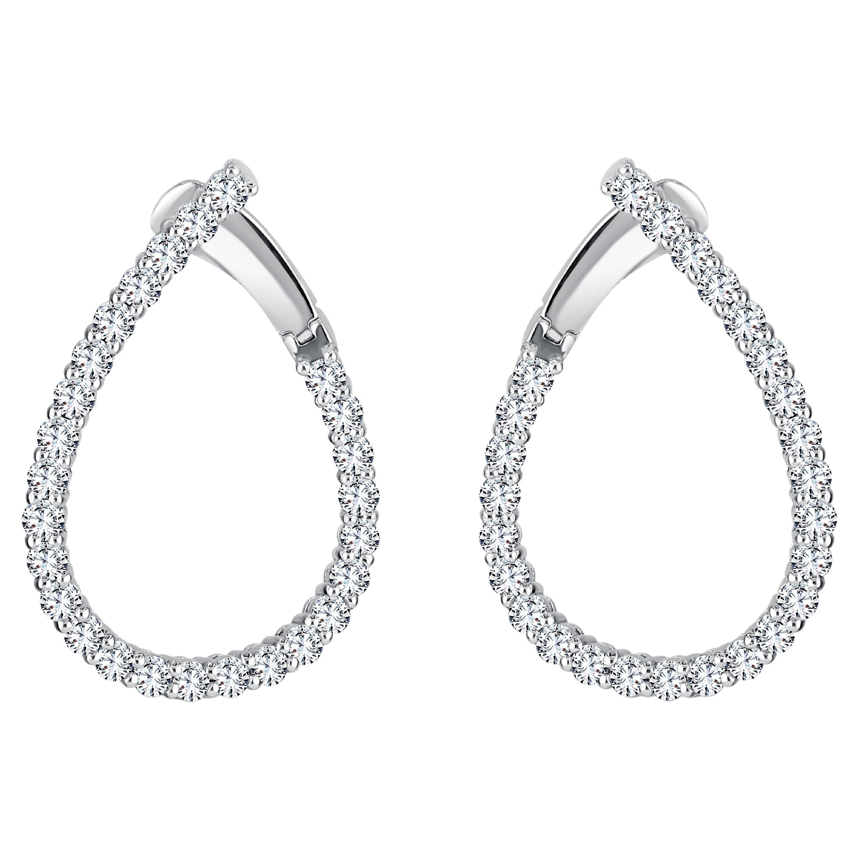 This pair of earrings showcases an exquisite arrangement of 2.19 carats of round white diamonds, elegantly placed along the gracefully twisting teardrop-shaped hoops. To ensure a secure and comfortable fit, a small lever serves as the closure behind