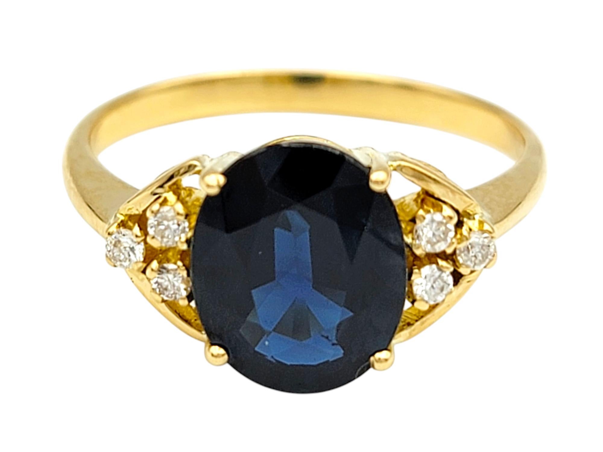 Contemporary 2.58 Carat Oval Cut Blue Sapphire Ring with Diamonds in 18 Karat Yellow Gold For Sale