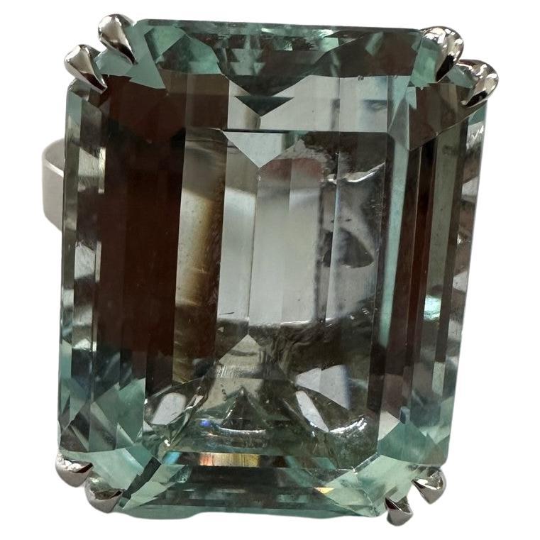 An 18K. white gold solitaire ring. (handmade)
an 8-sided emerald cut, Weight: 25.81 ct, dimensions: 20.21 x 16.04 x 10.65 mm
Light blue color without inclusions
22 brilliant cut diamonds together weighing: 0.28CT VSI/G
Weight of the total ring: