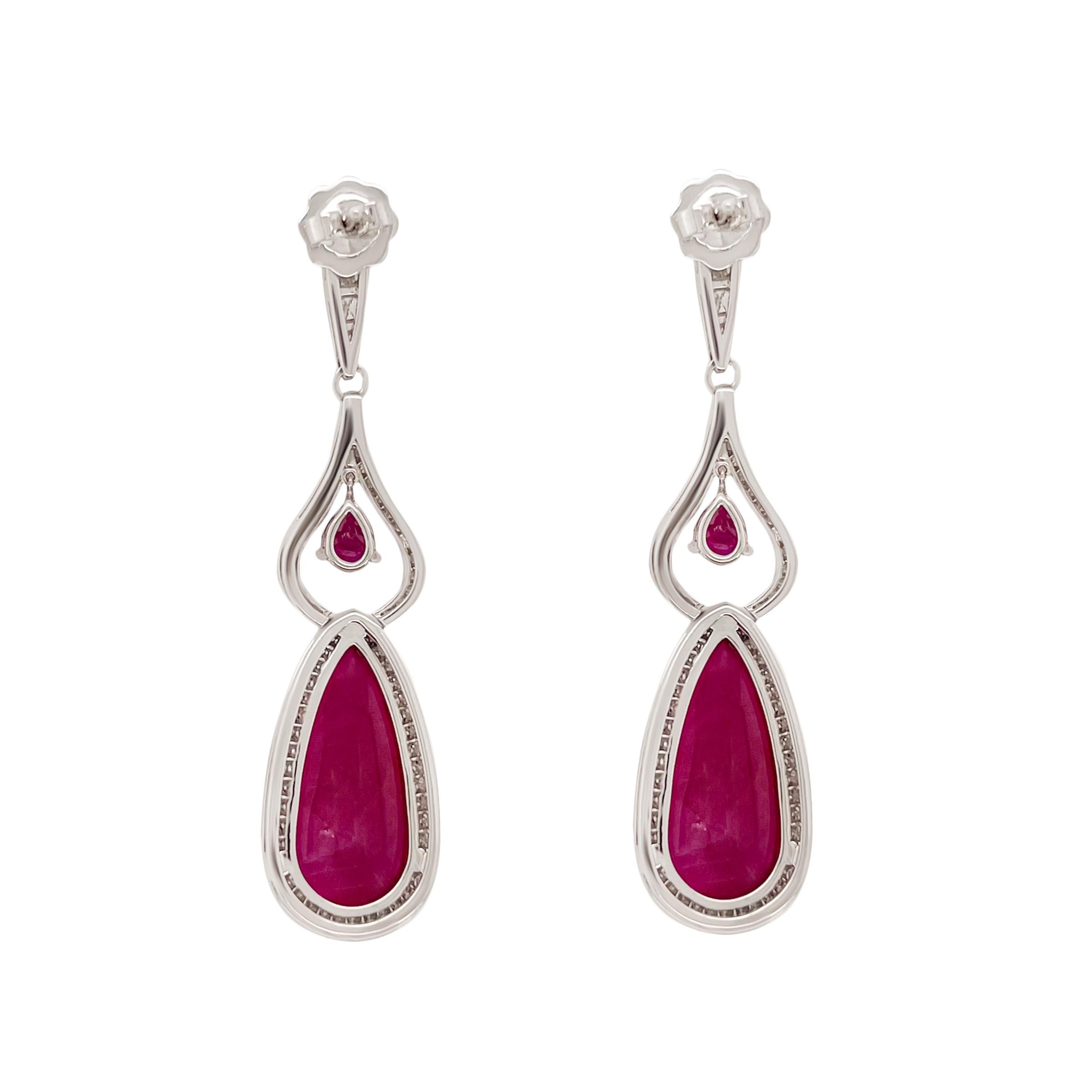 Two stunning ruby cabochon drops weighing 25.86 carats are the centrepiece to this sophisticated 18k white gold pair of earrings. 1.74 carats of white vvs1 diamond pave’ surround the rubies with an additional touch of faceted pear shaped red ruby to