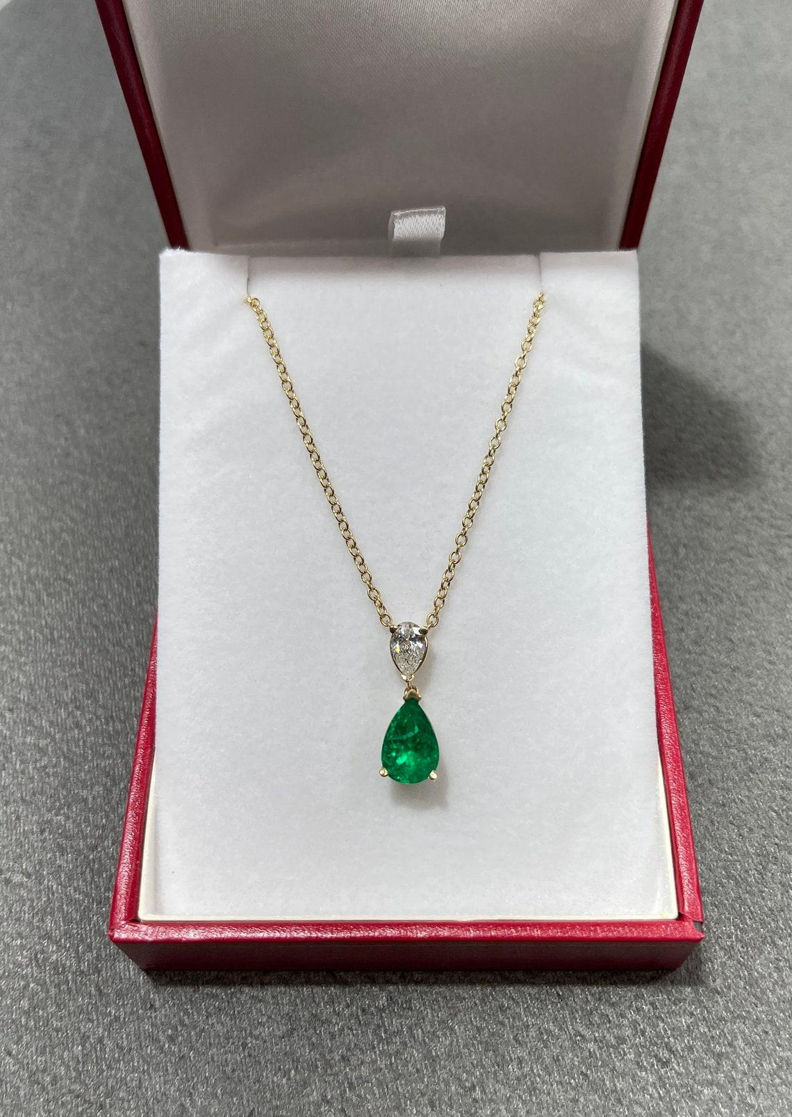 Take a look at this stunning Colombian emerald and diamond necklace. The natural, AAA+ high-quality Colombian emerald carries a full 2.12-carats of dark, vivid green color. The stone displays excellent luster and eye clarity. Accented at the top, is