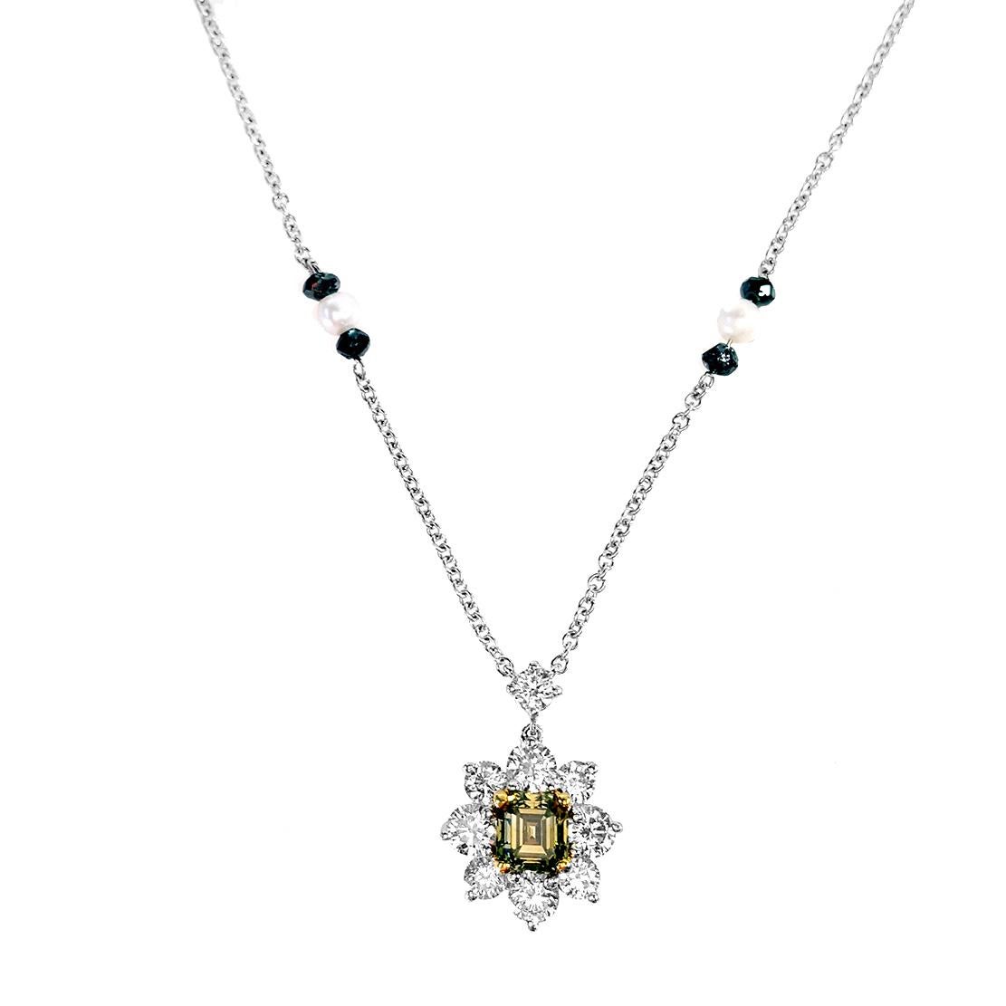 Featuring a stunning 0.50 carat emerald cut FANCY DARK
GRAY-GREENISH YELLOW diamond pendant necklace. certified by GIA as ‘CHAMELEON’. dropping from one round brilliant cut diamond and surrounded by 9 round brilliant white diamonds F color VS