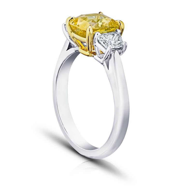 2.59 carat cushion (natural no heat) yellow sapphire with trapezoid diamonds .68 carats set in a platinum with 18k yellow gold ring.
