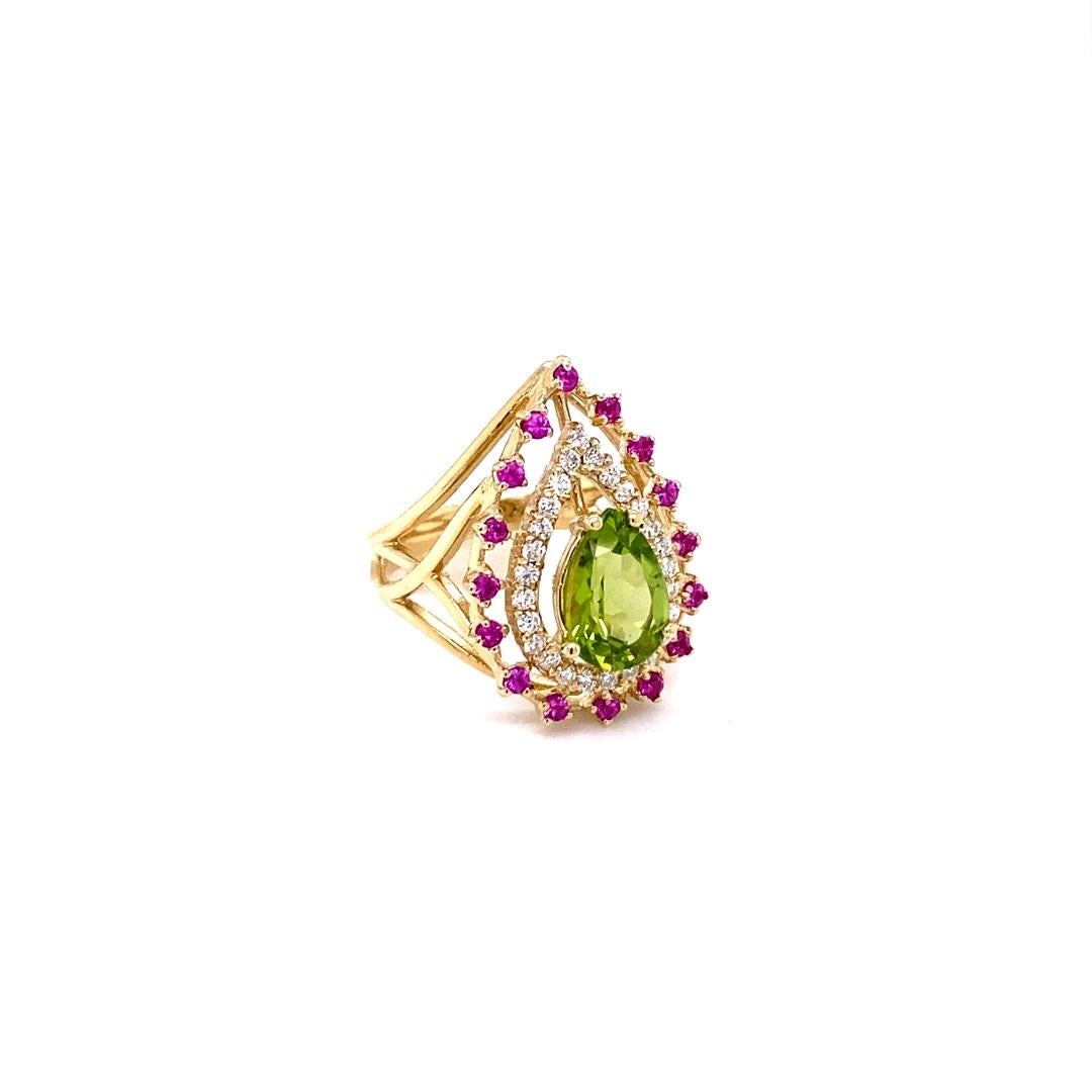This beautiful ring has an Pear Cut Peridot that weighs 1.92 Carats. The ring is surrounded by 16 Pink Sapphires that weigh 0.36 Carats and 26 Round Cut Diamonds that weigh 0.31 Carats. (Clarity: SI, Color: F)  The total carat weight of this ring is