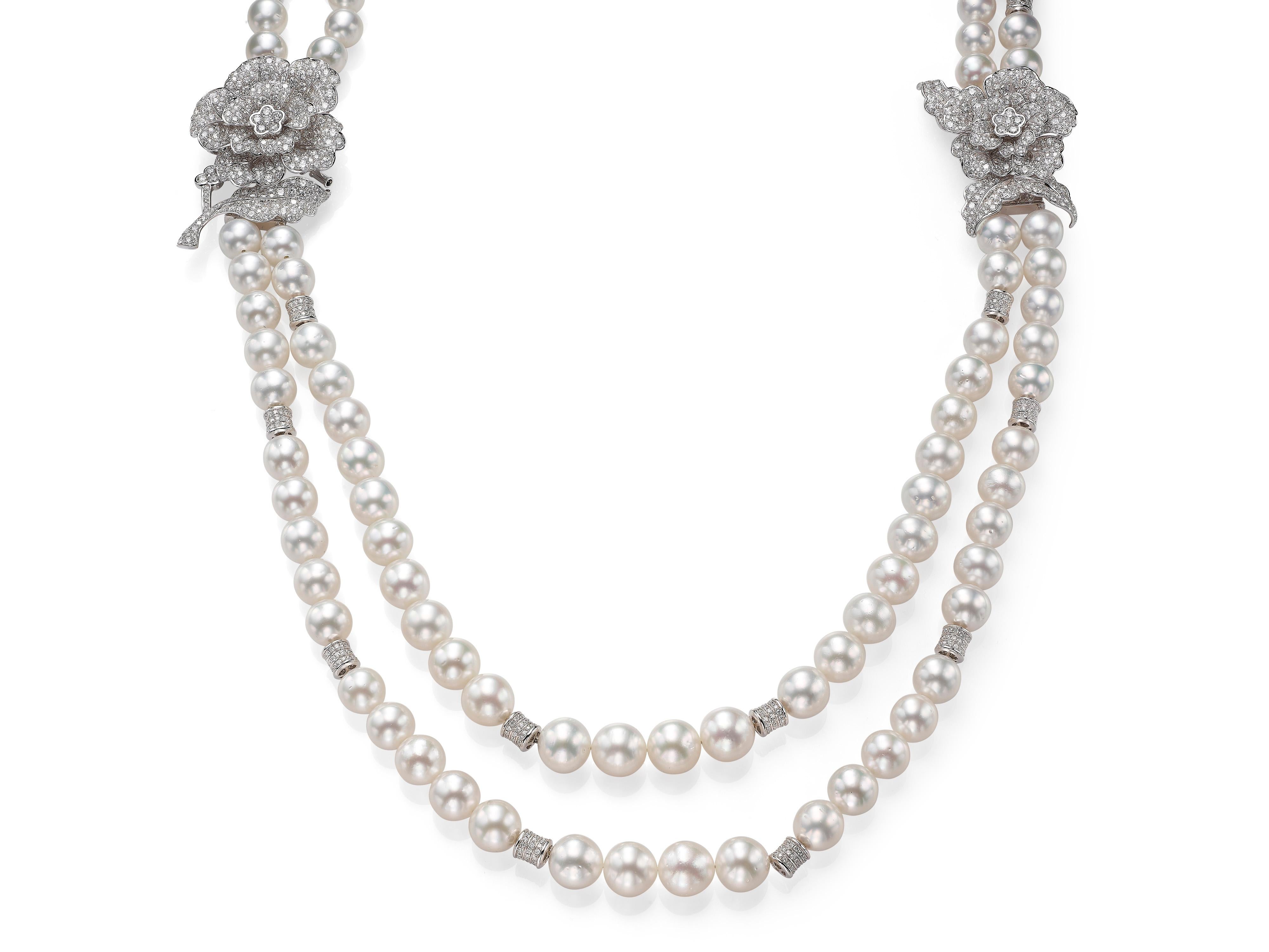 This marvelous Butani necklace exudes opulence and elegance.  Made from two strands of beautiful white South Sea Pearls (graduating from 9-13mm) and accented with two diamond floral pieces that can be detached and worn separately as brooches