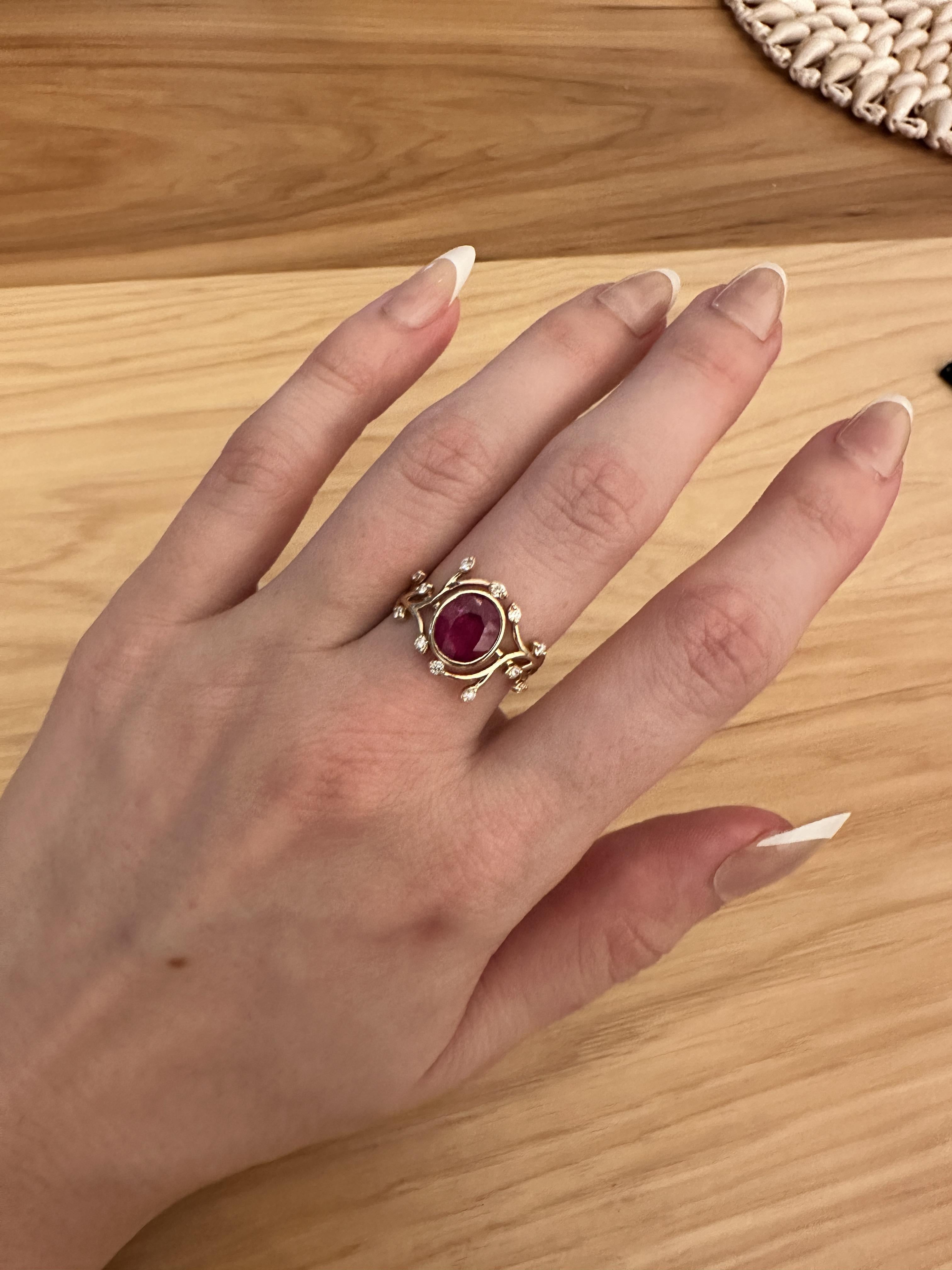 This exquisite Burma Ruby Ring is crafted with Solid 14k Yellow Gold, and features diamond accents for a perfect contrast. A beautiful 2.50ct Oval cut stone is surrounded by a nature-inspired elven vine pattern. The perfect way to express your
