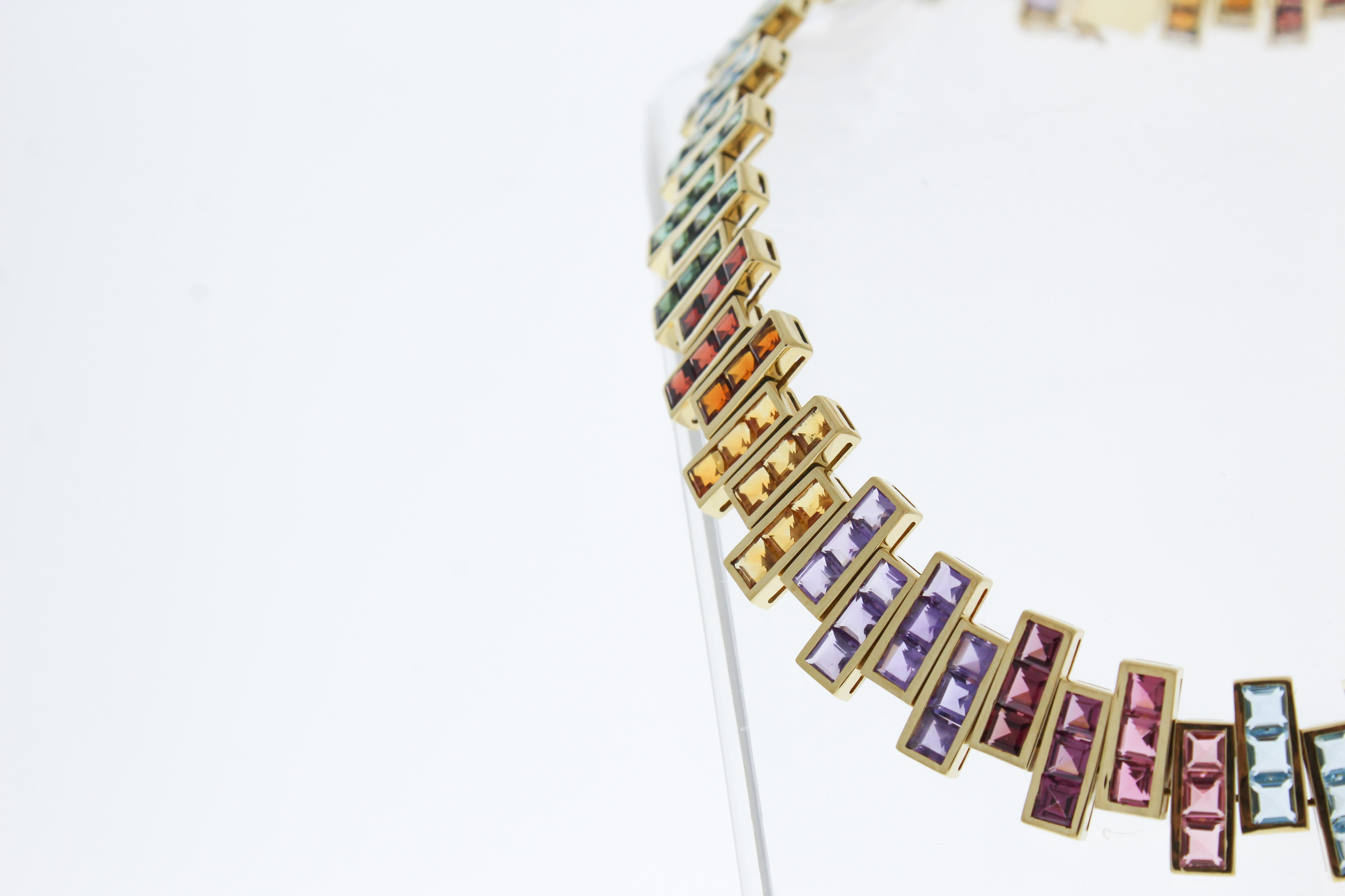 This stunning 18k Yellow Gold has an array of mixed gemstones that pop in color. This necklace features 207 princess cut gemstones, totaling up to 25CTW.
