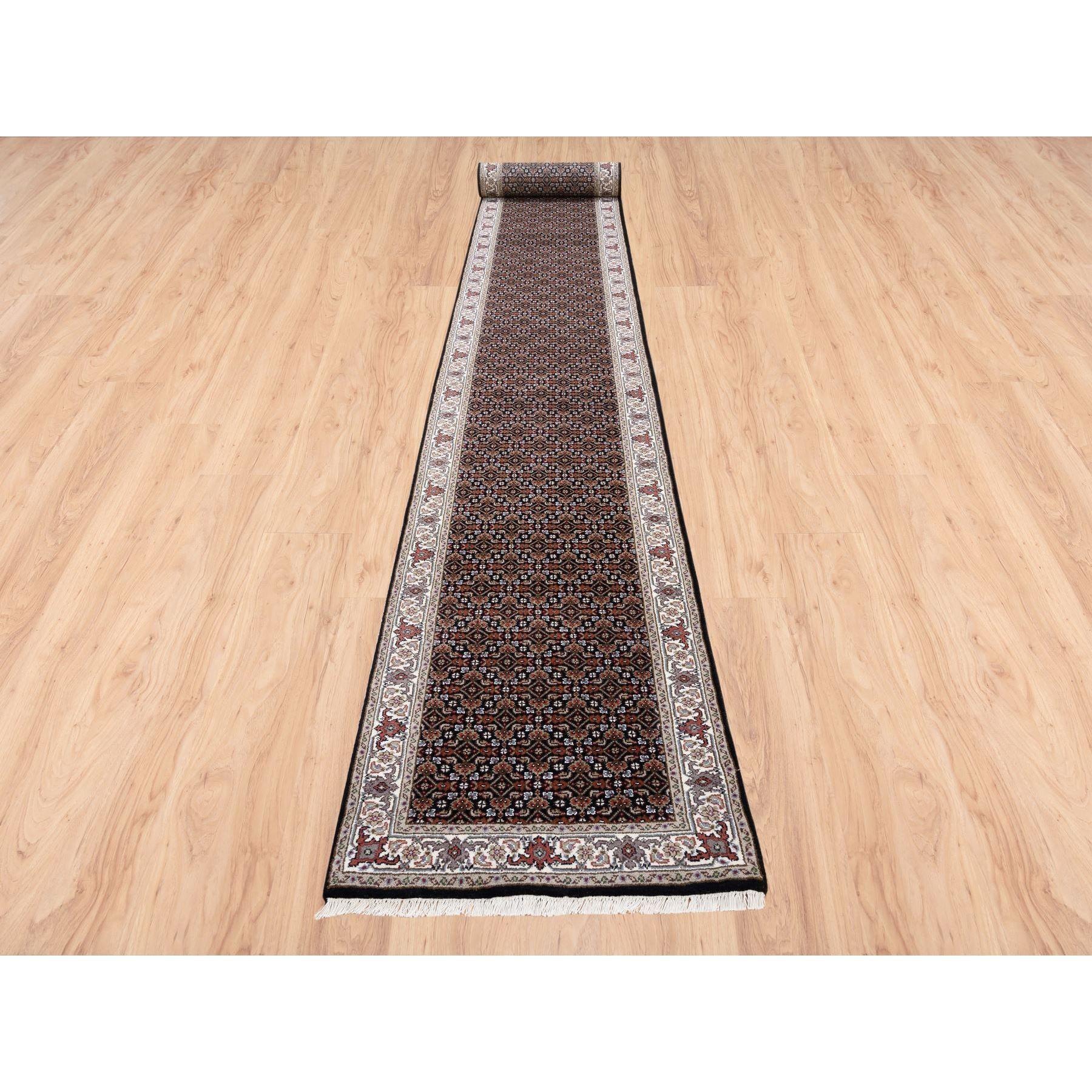 This is a truly genuine one-of-a-kind Rich Black Herati With All Over Design Luxurious Wool 175 KPSI Hand Knotted Oriental XL Runner Rug. It has been Knotted for months and months in the centuries-old weaving craftsmanship techniques by