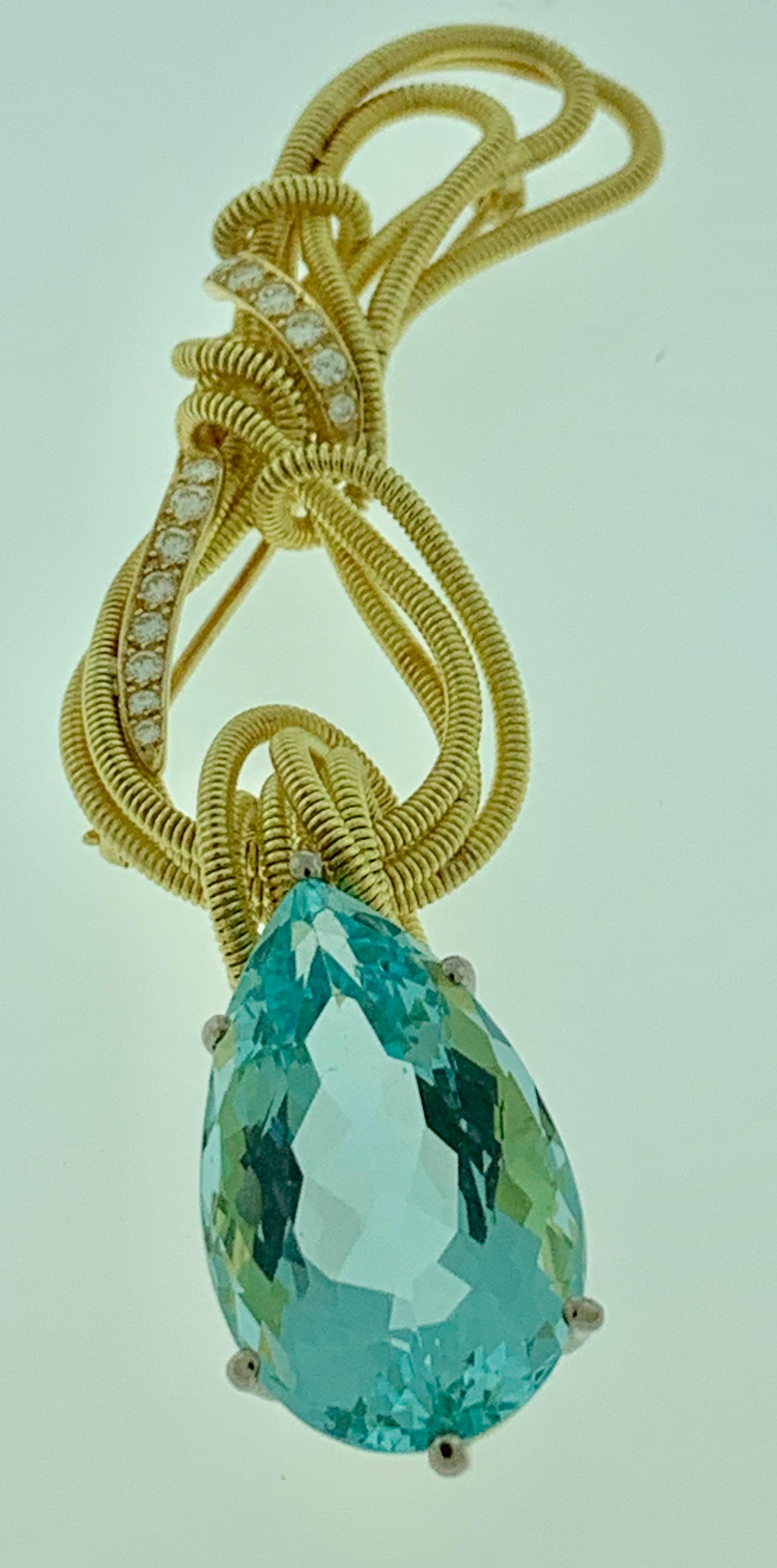  26 Carat  Aquamarine  &  Diamond Pendant /Pin  In 18K Yellow Gold  by Designer Gloria Bass

This spectacular Pendant Necklace  consisting of a single Pear cut  Aquamarine approximately  26 Carat.  
The  Aquamarine   is  a drop from 18 Karat yellow