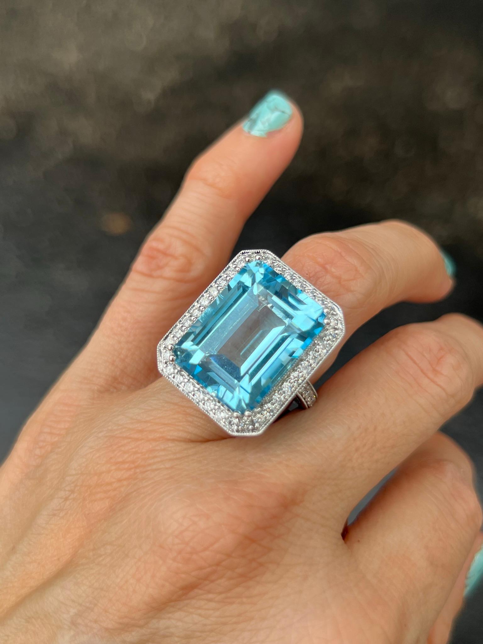 14K white gold cocktail ring with 26.75 carat emerald cut blue topaz.

Features
14K white gold
26.75 carat Swiss Blue, blue topaz with an emerald cut
1 carat total weight in diamonds
The measurement of the blue topaz stone is aprrox. 20 x 15 mm
The