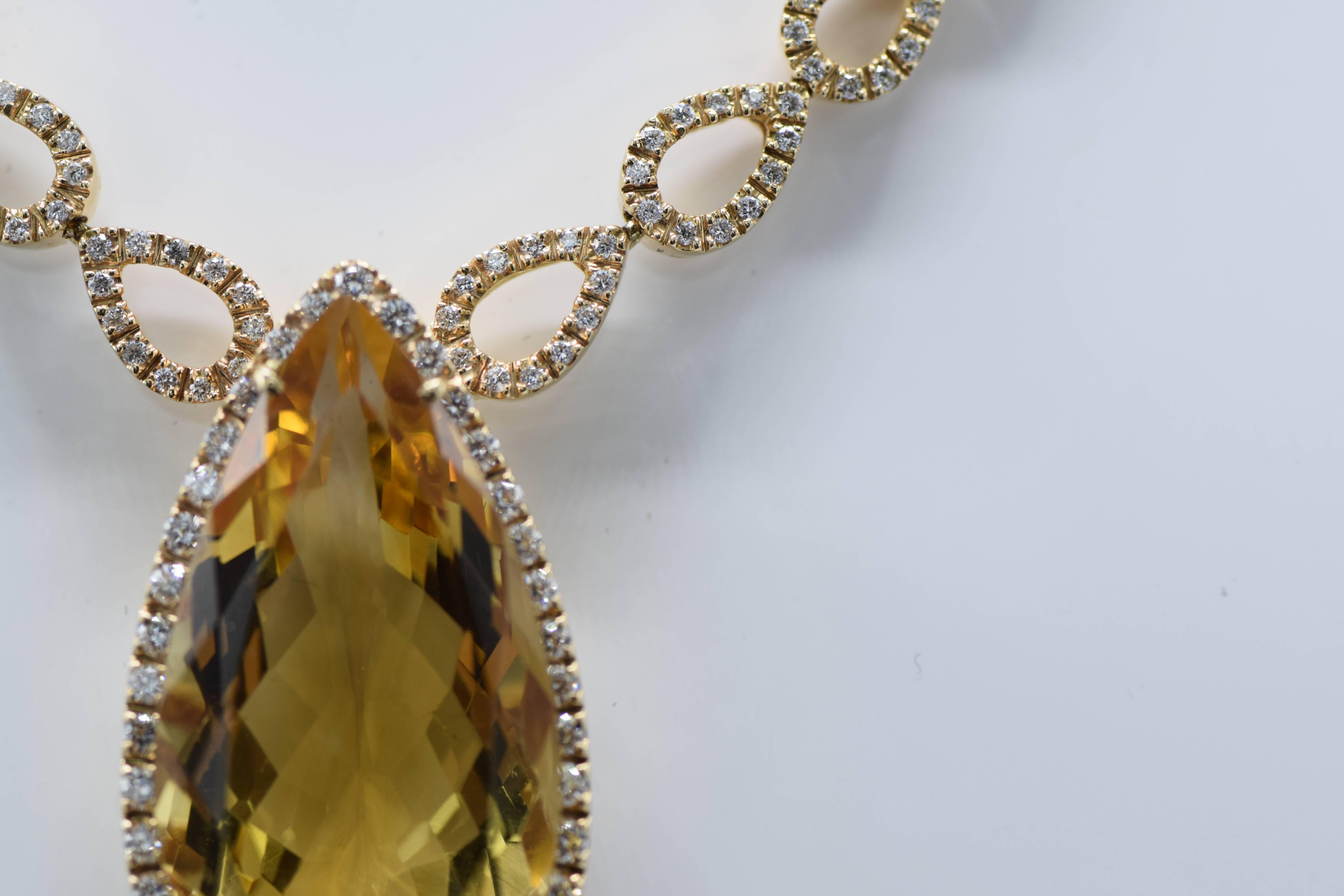 Suspending a pear-shaped citrine weighing approximately 26.00 carats, framed by a border of round diamonds, joined to diamond-set and polished pear-shaped linking, mounted in 18k pink gold,

Citrine: a medium tone of golden yellow color 

Diamonds: