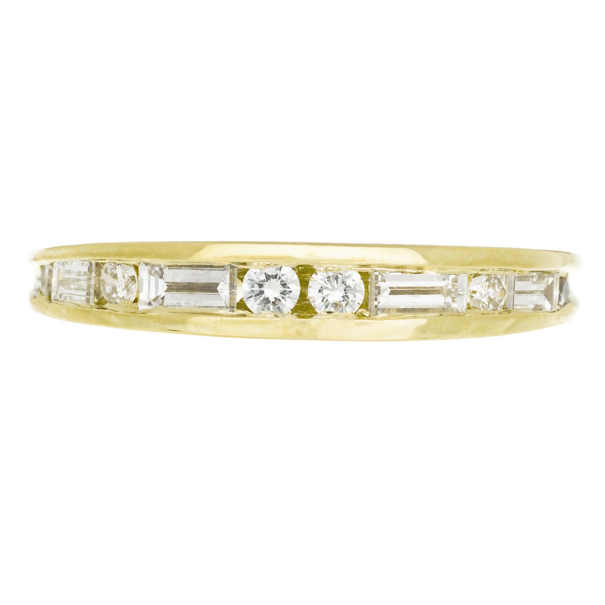 Domed diamond channel set wedding band. 18k yellow gold with 6 round brilliant cut and 4 step cut baguette diamonds. 

6 round brilliant cut diamonds, H VS approx. .12cts
4 step cut baguette diamonds, H VS approx. .14cts
Size 6 and sizable
18k