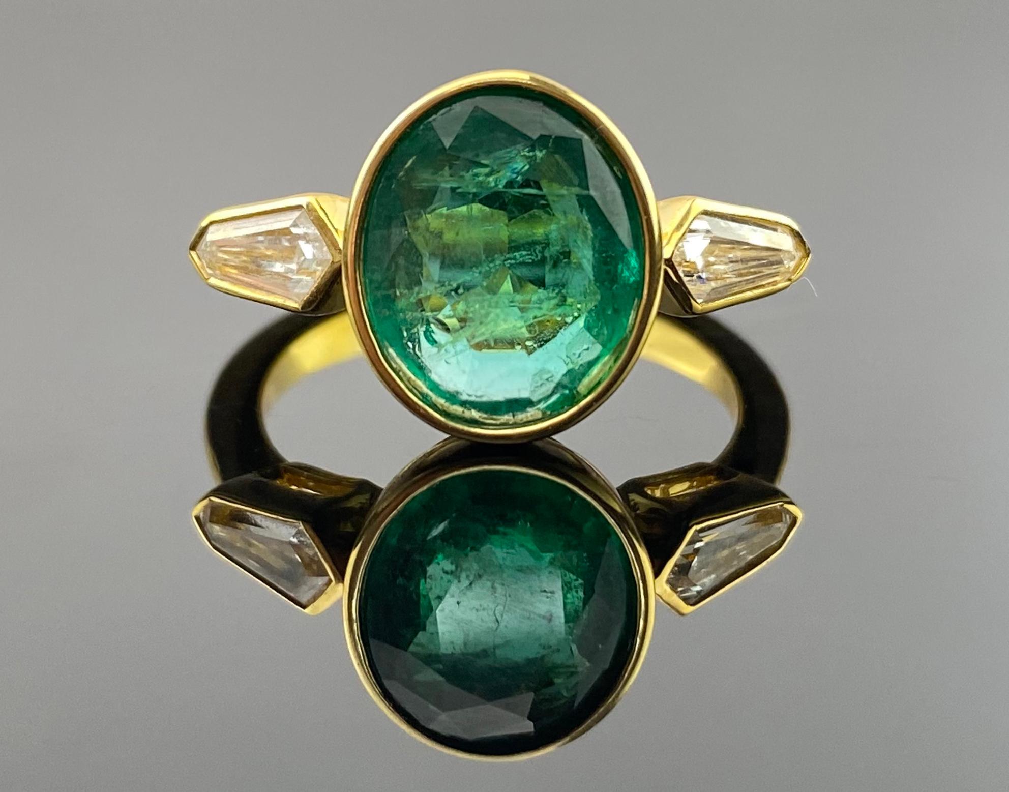 Elevate your style with this exquisite 18K gold ring, featuring a stunning 0.52-carat diamond and a captivating 2.6-carat oval-shaped Zambian Emerald. The combination of these two precious gemstones in a lustrous 18K gold setting creates a