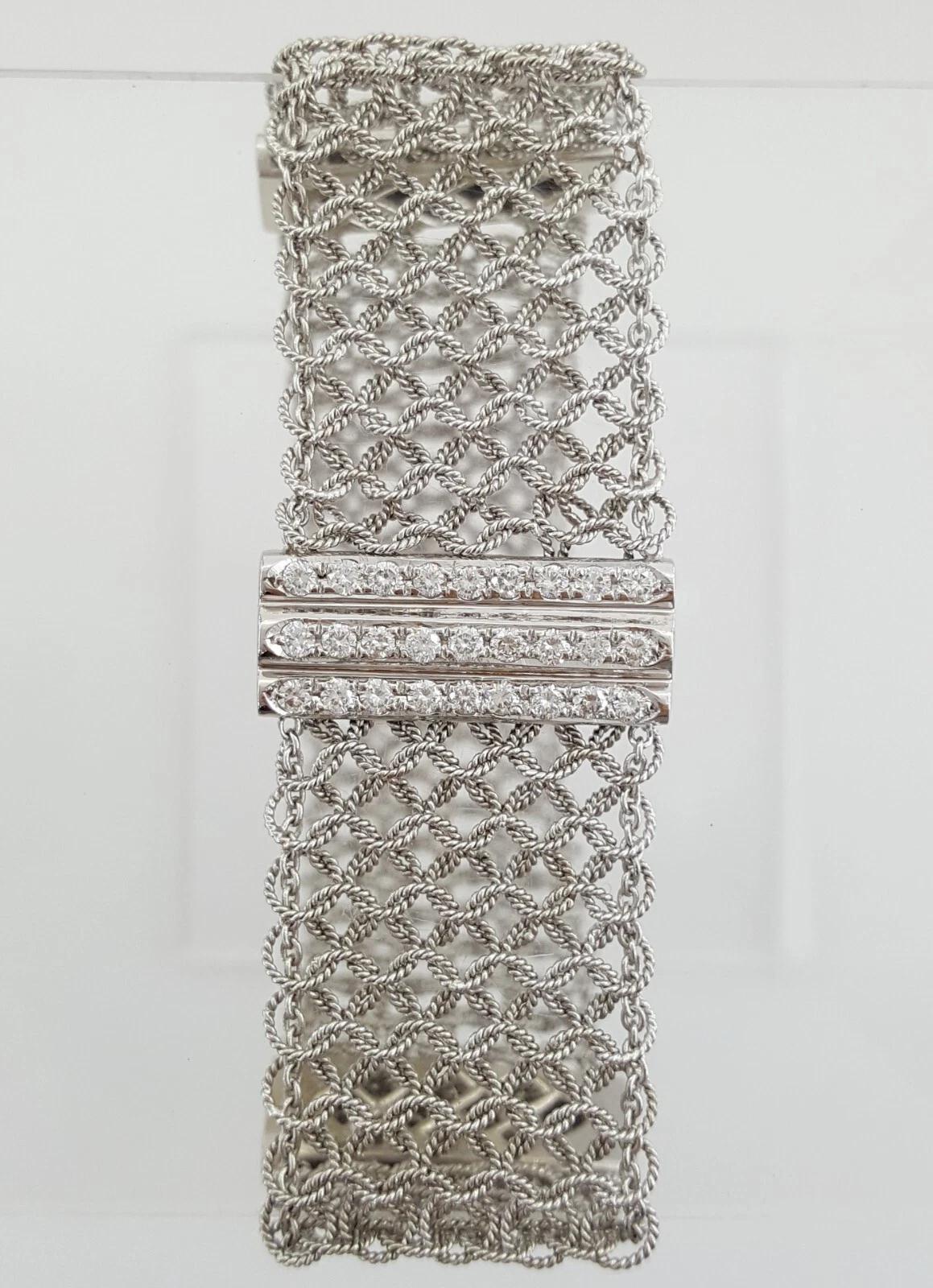A striking blend of bold design and refined craftsmanship, this luxurious mesh bracelet is meticulously crafted in 18K white gold and adorned with approximately 2.6 carats of natural round brilliant cut diamonds. The diamonds, graded F-H in color