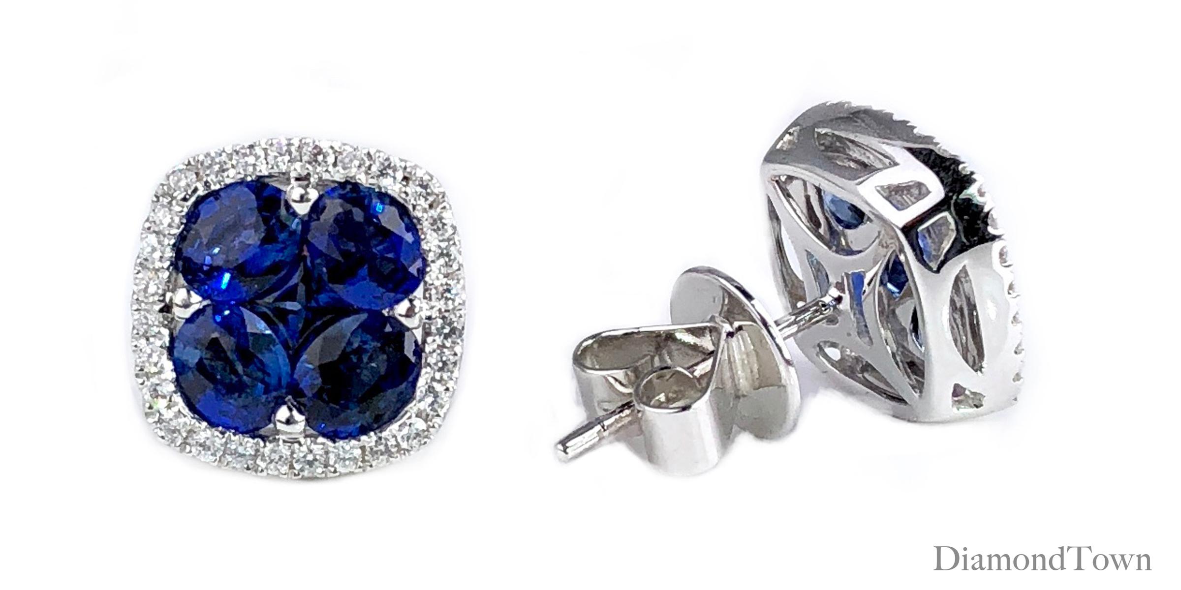 These stud earrings feature a cluster center of blue sapphires (five stones per earring, total weight 2.6 carats) surrounded by a halo of round white diamonds (total diamond weight 0.21 carats), set in 18k white gold.

DiamondTown is pleased to