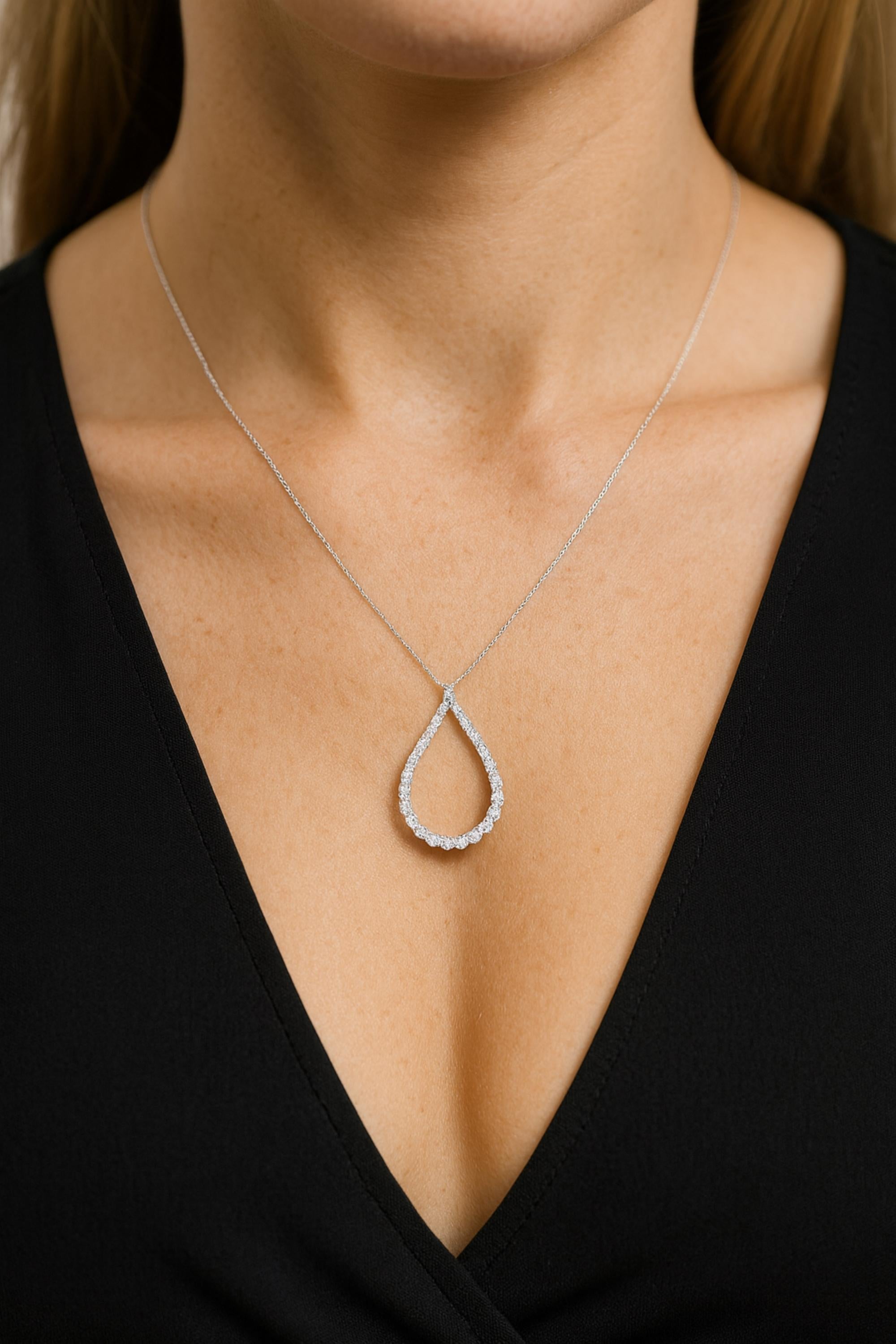 This 2.6 Carat SI Clarity HI Color Diamond 14 Karat White Gold Drop Pendant Necklace features graduated round cut diamonds set in the pear shape pendant. 
Diamonds are a universal symbol of eternity and strength. It is a April Birthstone and perfect