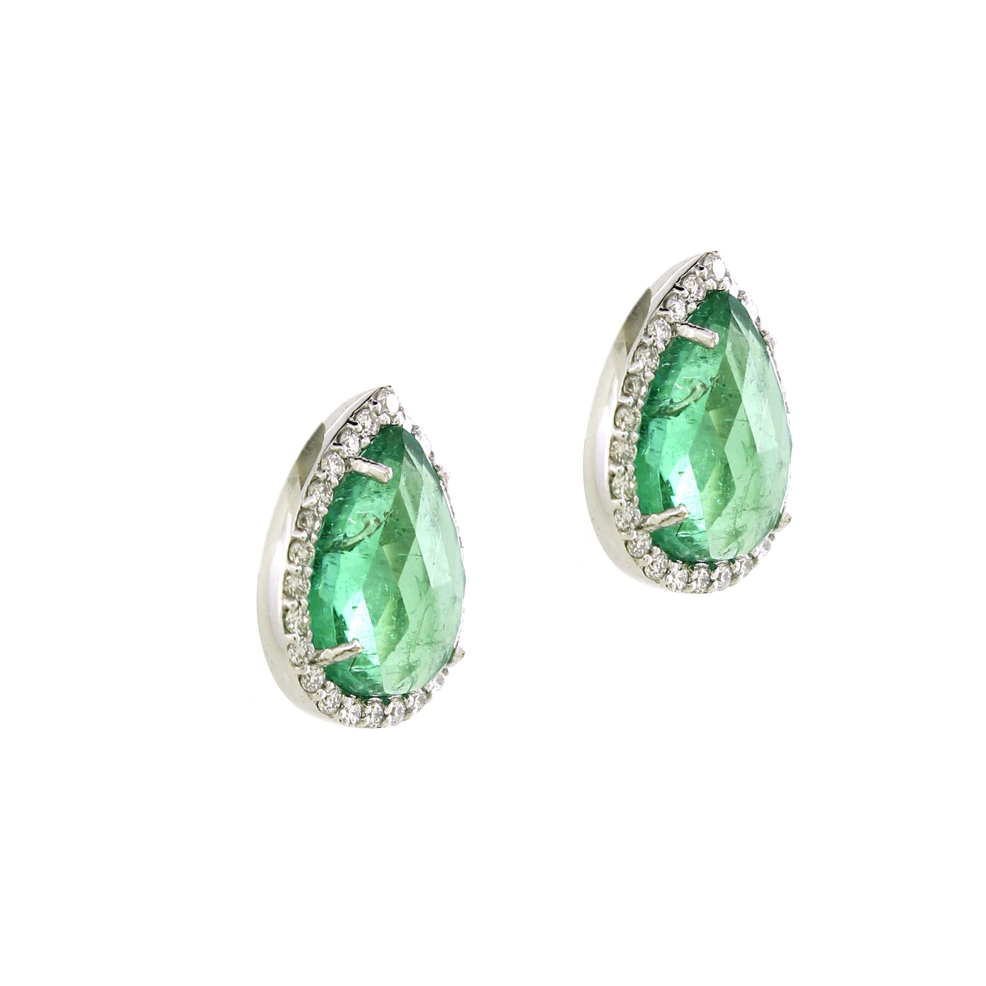 Introducing our elegant Stud Earrings, featuring two exquisite pear-cut light green tourmalines of 2.6 cts. These stunning tourmalines are the centerpiece, radiating a delicate and refreshing hue that captivates and enchants. Surrounding each
