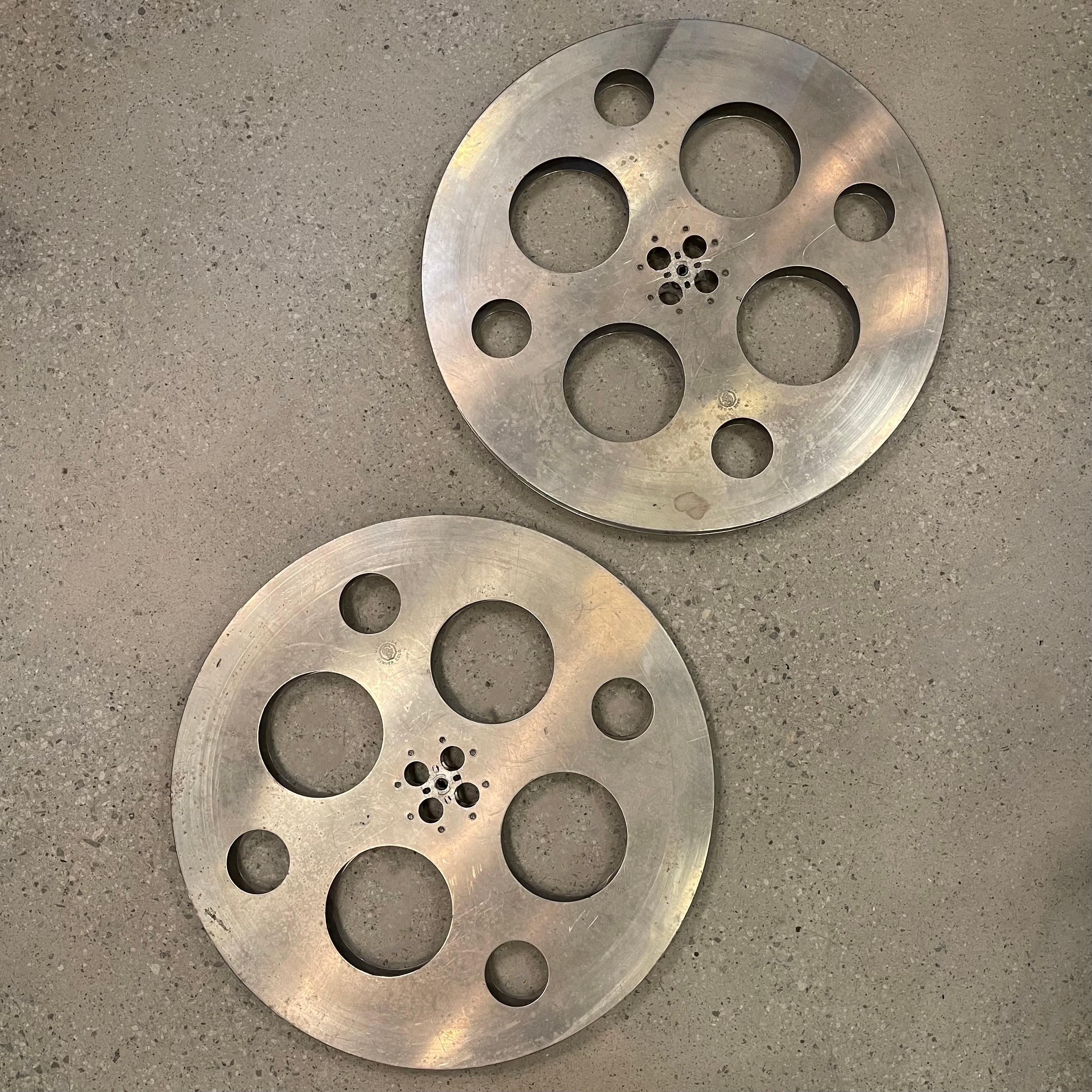Large, 26 inch diameter, industrial, midcentury, film reels by Goldberg Brothers are great accent pieces or wall hangings. The reels are clean on both sides.  Sold individually, two 26 inch reels are available. Two 24