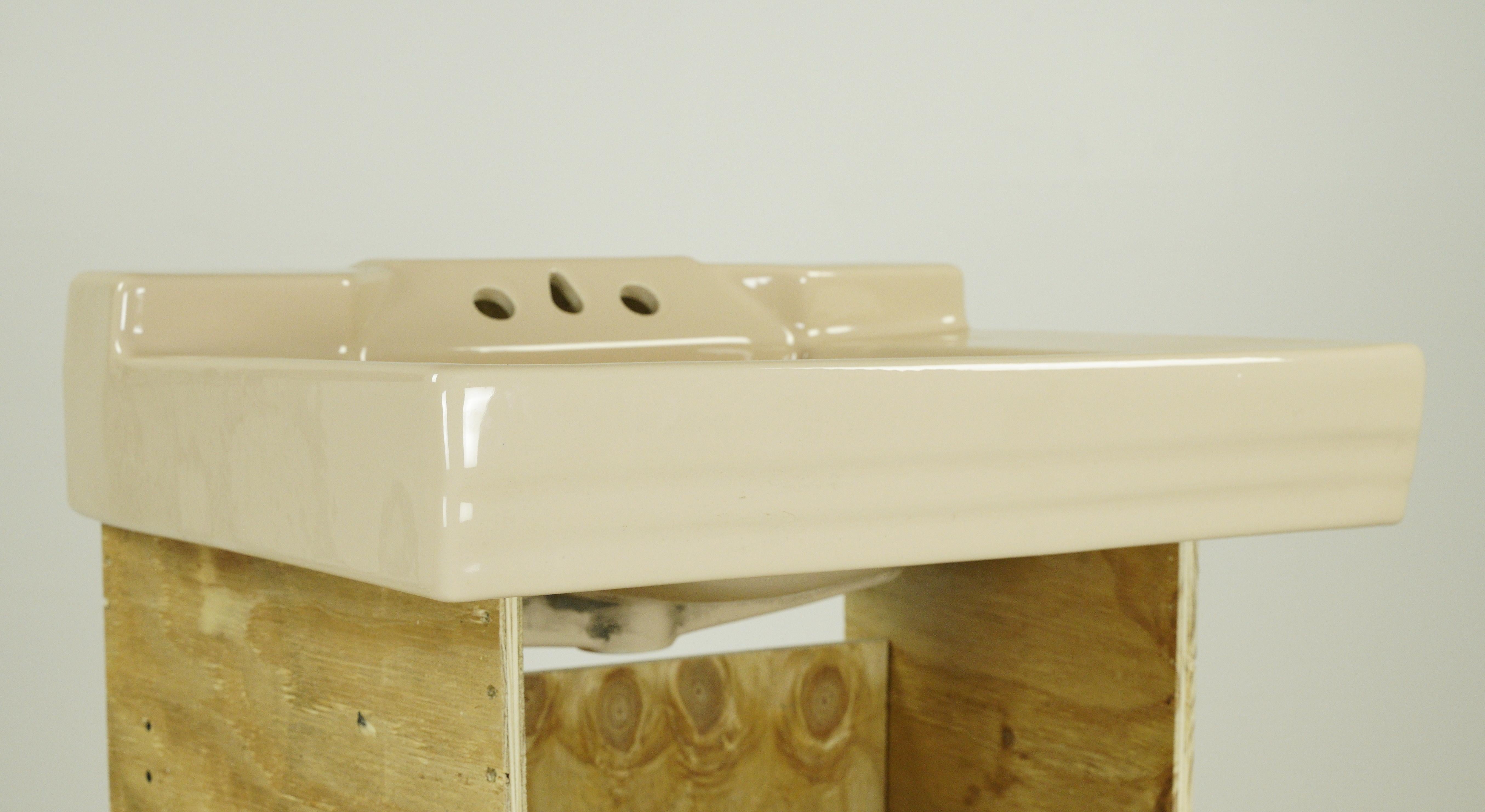 Muted light pink or warm tan porcelain ceramic rectangular wall sink with a trapezoid shape. No hardware is included. Great vintage condition. By Rheem Manufacturing. One available. Please note, this item is located in our Scranton, PA location.