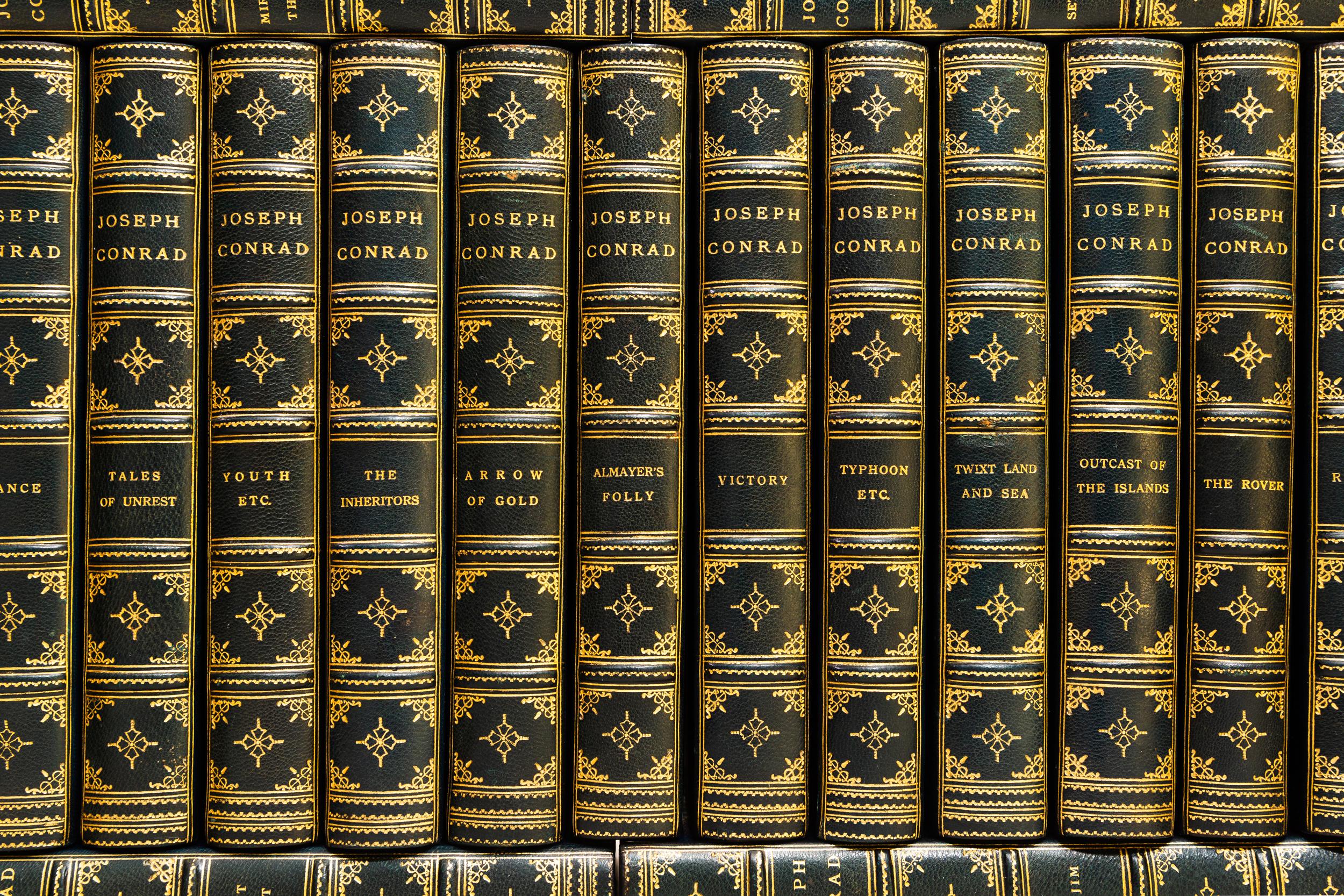 26 Volumes. Joseph Conrad, The Works of Joseph Conrad. Bound in 3/4 blue morocco. Linen boards. Raised bands. Top edges gilt. Decorative gilt emblems on spines. Marbled endpapers. Published: New York 1925.