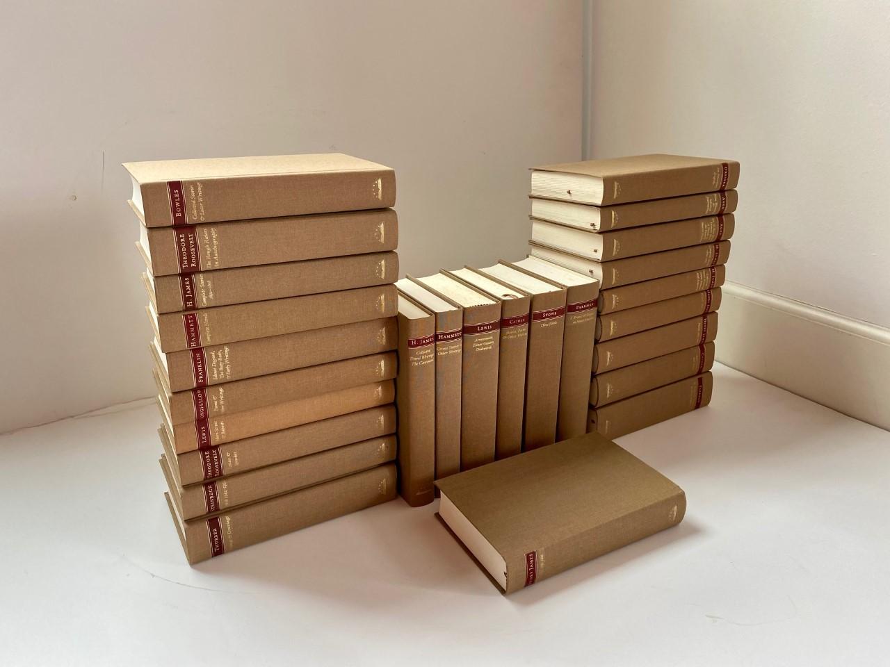 Beautiful set of 26 volumes of The Library of America. This set is a classic and beautifully finished in a tan linen that makes it current and classic at the same time. A look that is classic, minimalist and expensive. Each book comes with its on