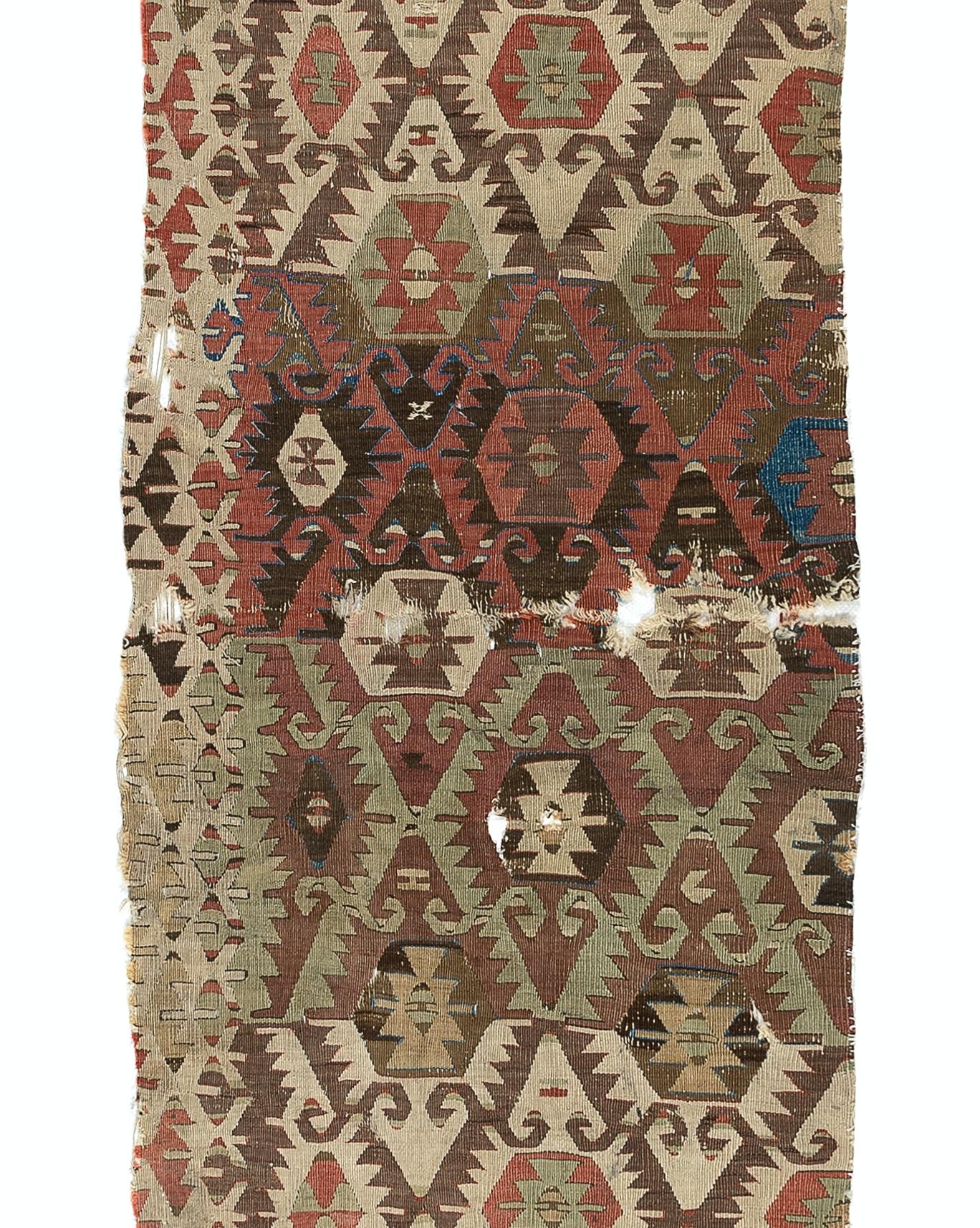 Embark on a journey through time and tradition with this exquisite Antique Turkish fragment distressed kilim, a rare artifact dating back to the 18th century. Crafted with meticulous skill and artistry by Anatolian weavers over three centuries ago,