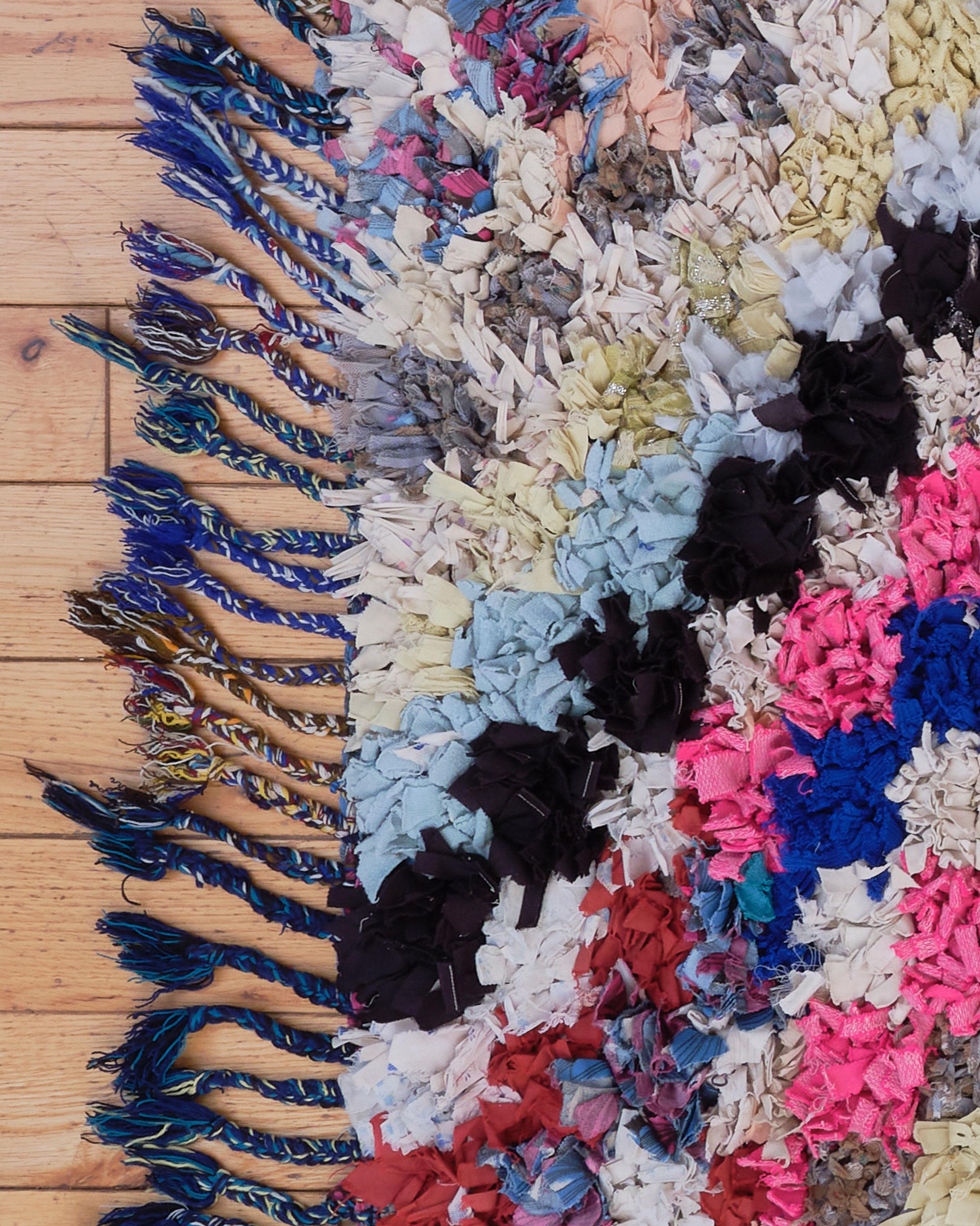 The Bou 09 rug is a stunning Boucherouite piece, handwoven by Berber women in Morocco using a combination of cotton and 100% natural sheep's wool. This multicolor rug showcases vibrant, eye-catching hues and irregular patterns, reflecting the