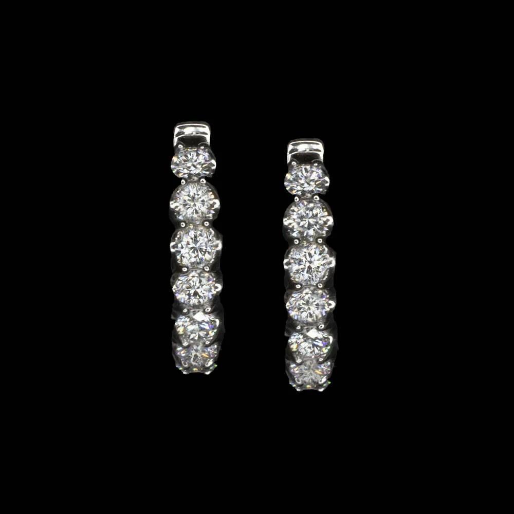 These beautiful 14k white gold diamond hoop earrings feature 2.60 carats of bright, eye-clean round brilliant cut diamonds. 

The G-H color and SI1-SI2 clarity diamonds offer vibrant sparkle, and the in-and-out design ensures maximum brilliance from