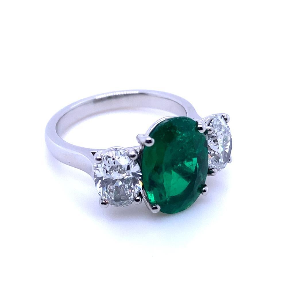 A 2.60 carat Columbian emerald and diamond three stone platinum engagement ring.

This beautiful emerald and diamond engagement ring is handcrafted in platinum. The piece is claw set to its centre with an exceptional oval cut emerald of 3.30 carats.