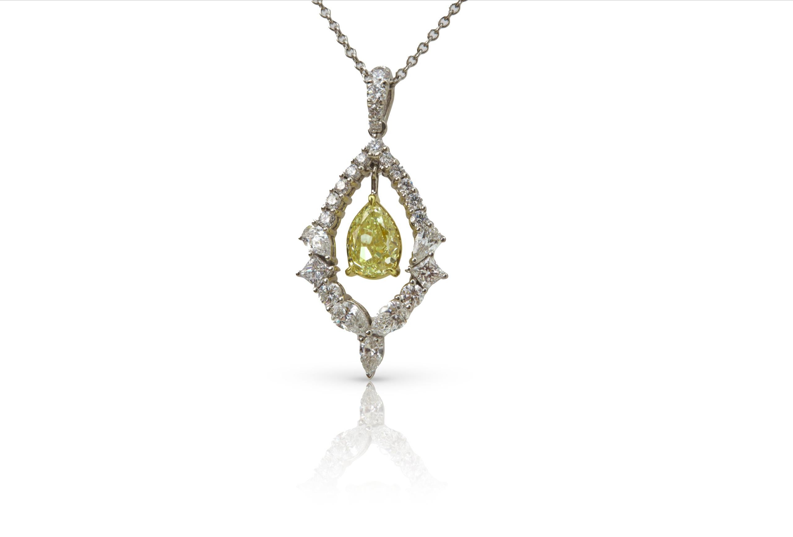 Featuring a stunning a 2.61 carat pear shaped Fancy Yellow color diamond pendant. certified by GIA as VVS1 clarity. The pendant is styled with a pear-shaped fancy yellow diamond in a floating prong setting, surrounded by a mix of pear-shaped and