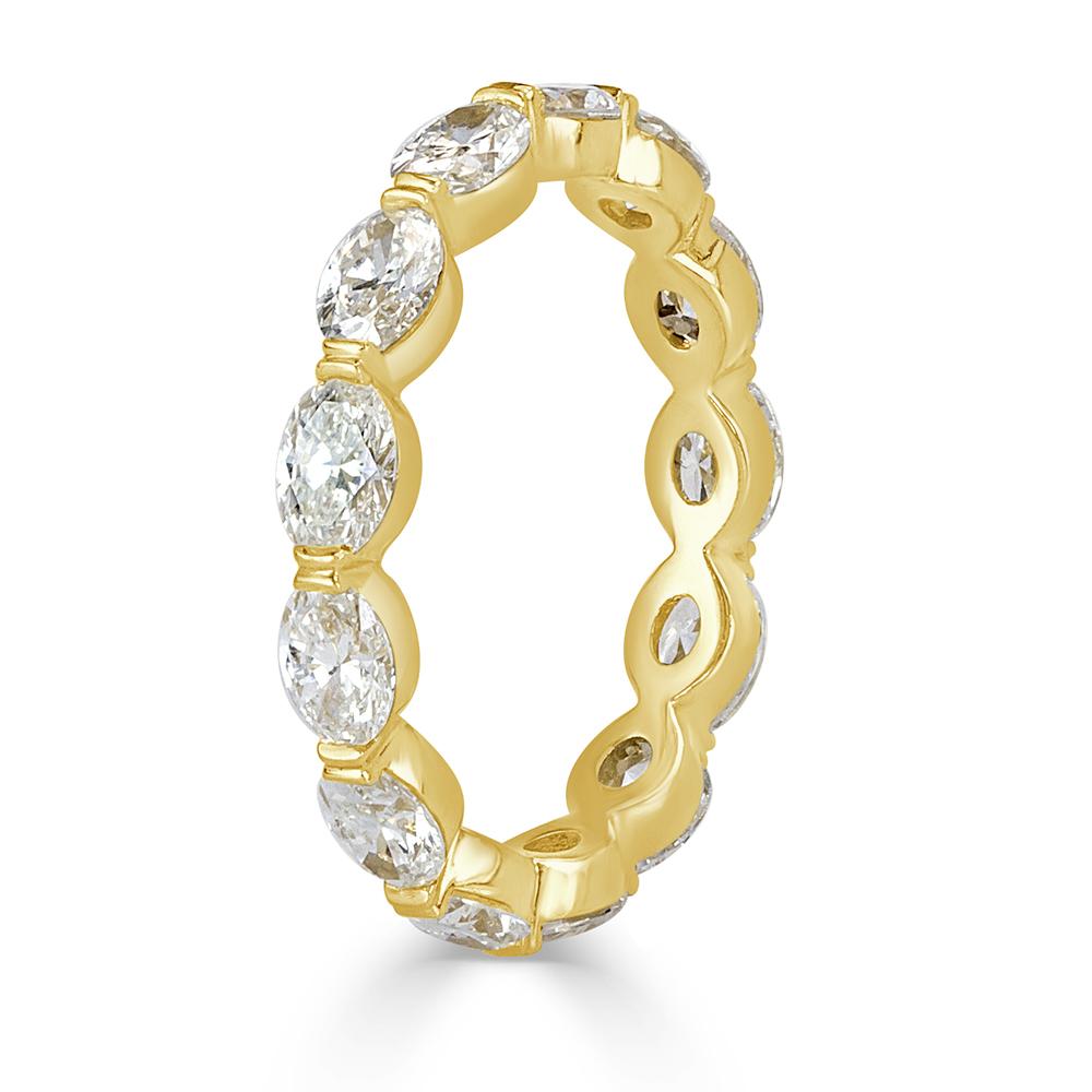 This exquisite diamond eternity band features 2.60ct of perfectly matched oval cut diamonds hand set in an 18k yellow gold, single prong setting style. The diamonds are graded at E-F, VS1-VS2. All eternity bands are shown in a size 6.5. We custom