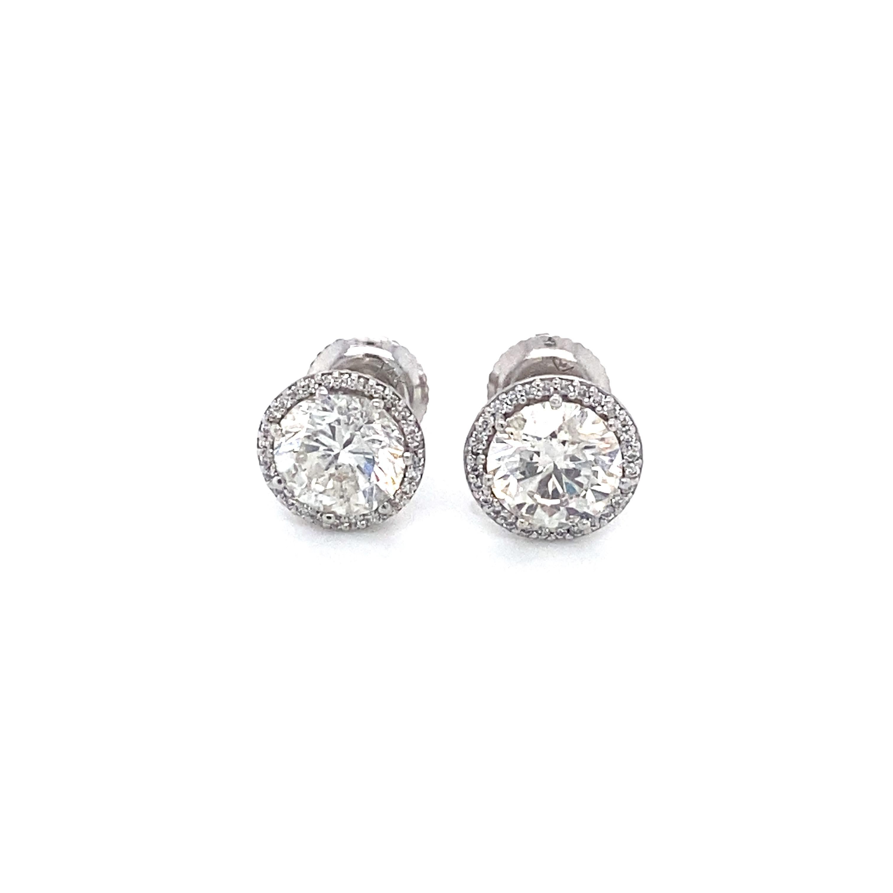 Item Details: These sparkling earrings have large round diamonds and accent detailing on the underside and have screw back closures.

Circa: 2000s
Metal Type: 14 Karat White Gold 
Weight: 1.7 grams 

Diamond Details:

Carat: 2.60 carat total weight