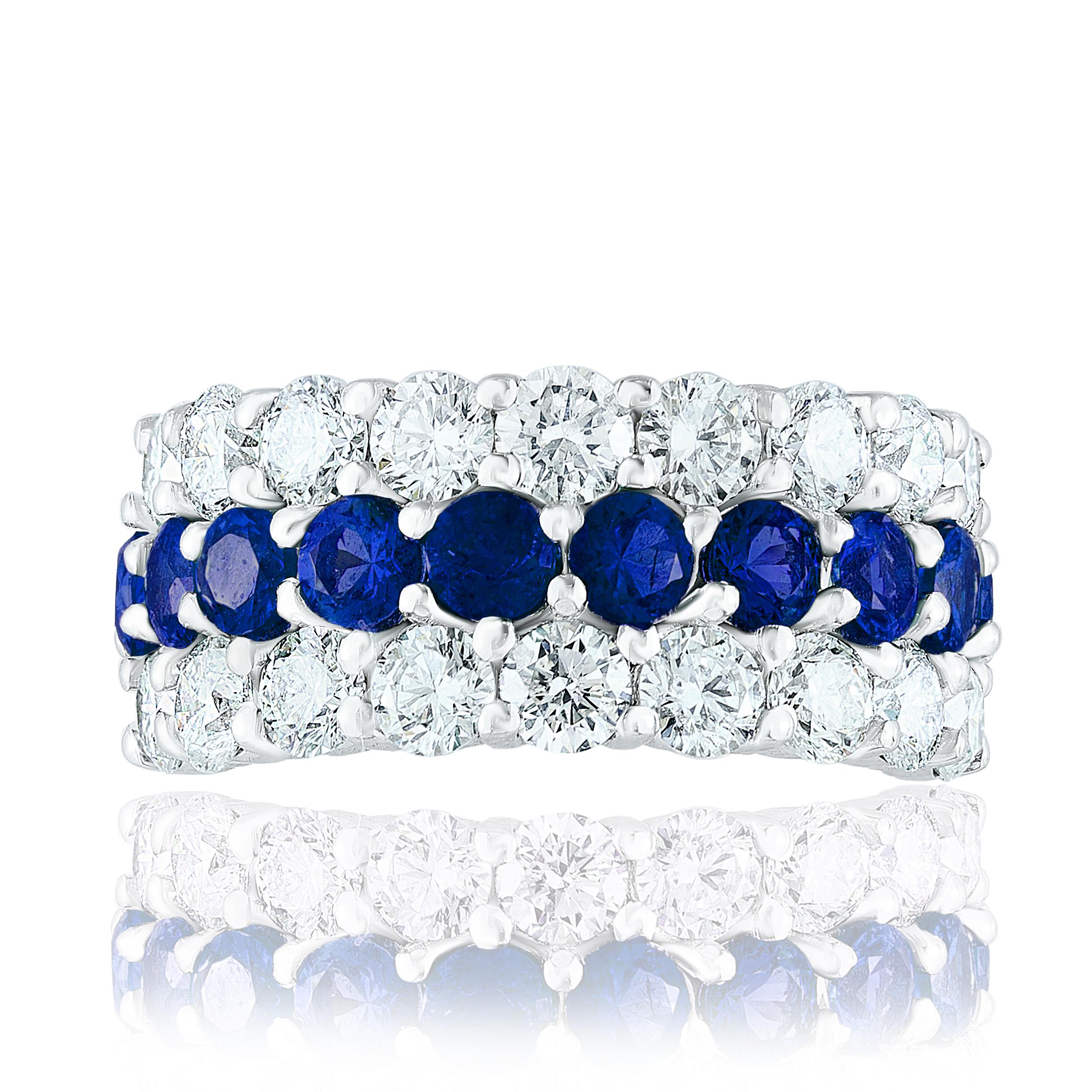 A unique and fashionable ring showcasing two rows of round-shape 18 diamonds and one row of 10 vibrant blue sapphires in the middle, set in a band design. Blue Sapphire weigh 2.60 carats and Diamonds weigh 2.70 carats total. A brilliant and