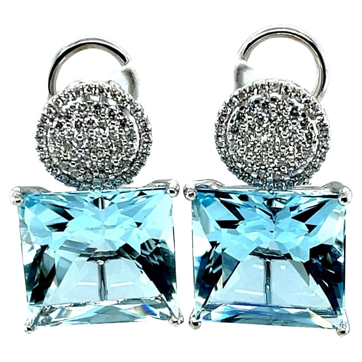 These bold earrings feature two spectacular square-cut aquamarines that weigh a total of 26 carats. The aquamarines have a deep blue color and are very large, measuring 15mm across. It is highly unusual to find a beautifully matched pair of