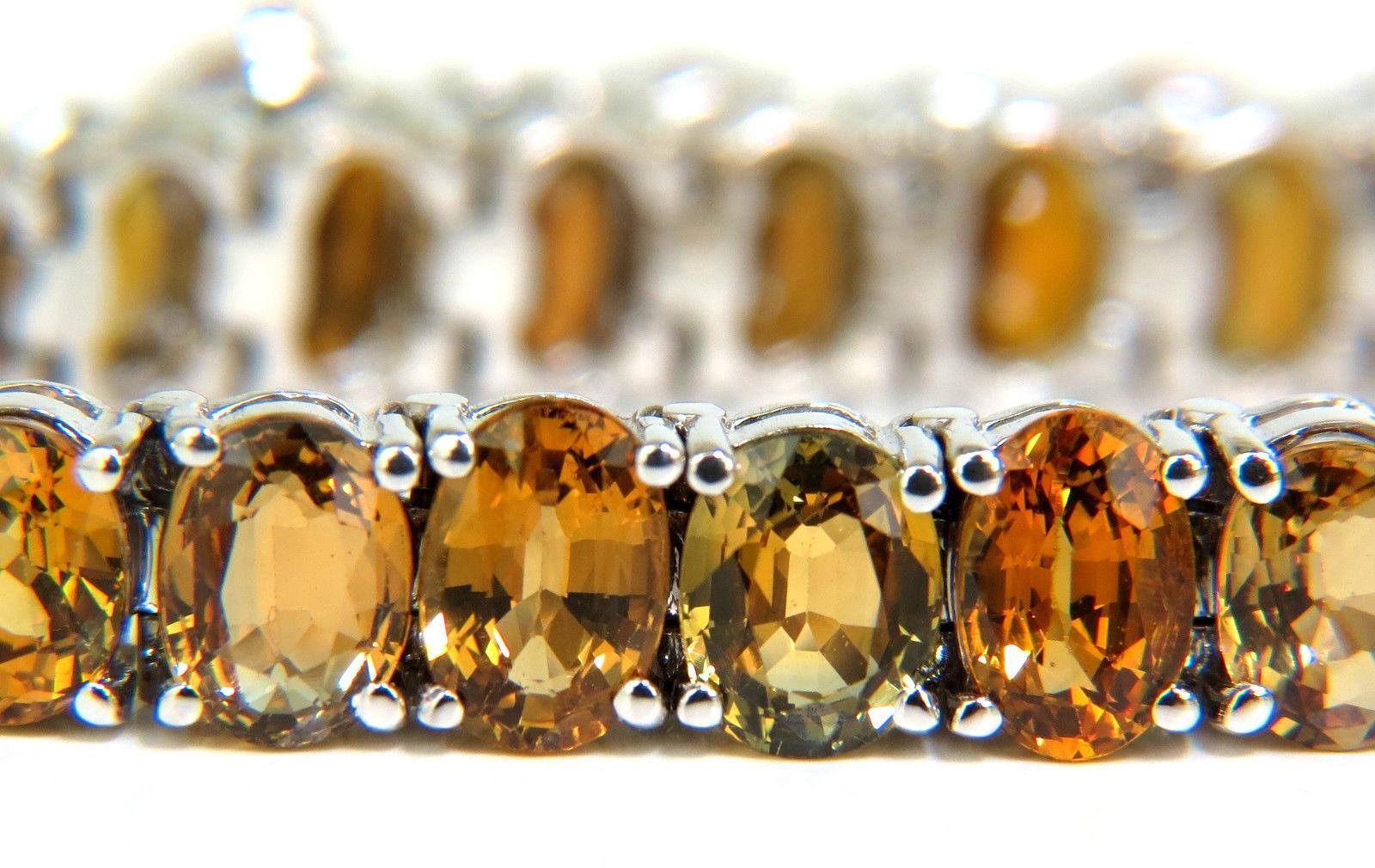 Rare 26.00ct. Natural Sapphires 

 Orange - yellow - brown colors

Clean Gem clarity

Excellent range of colors

no two are alike!

38 sapphires in total

Average 6.2 X 4.5mm

Full cuts

7 inches long

14kt white gold

$5200 appraisal will accompany 