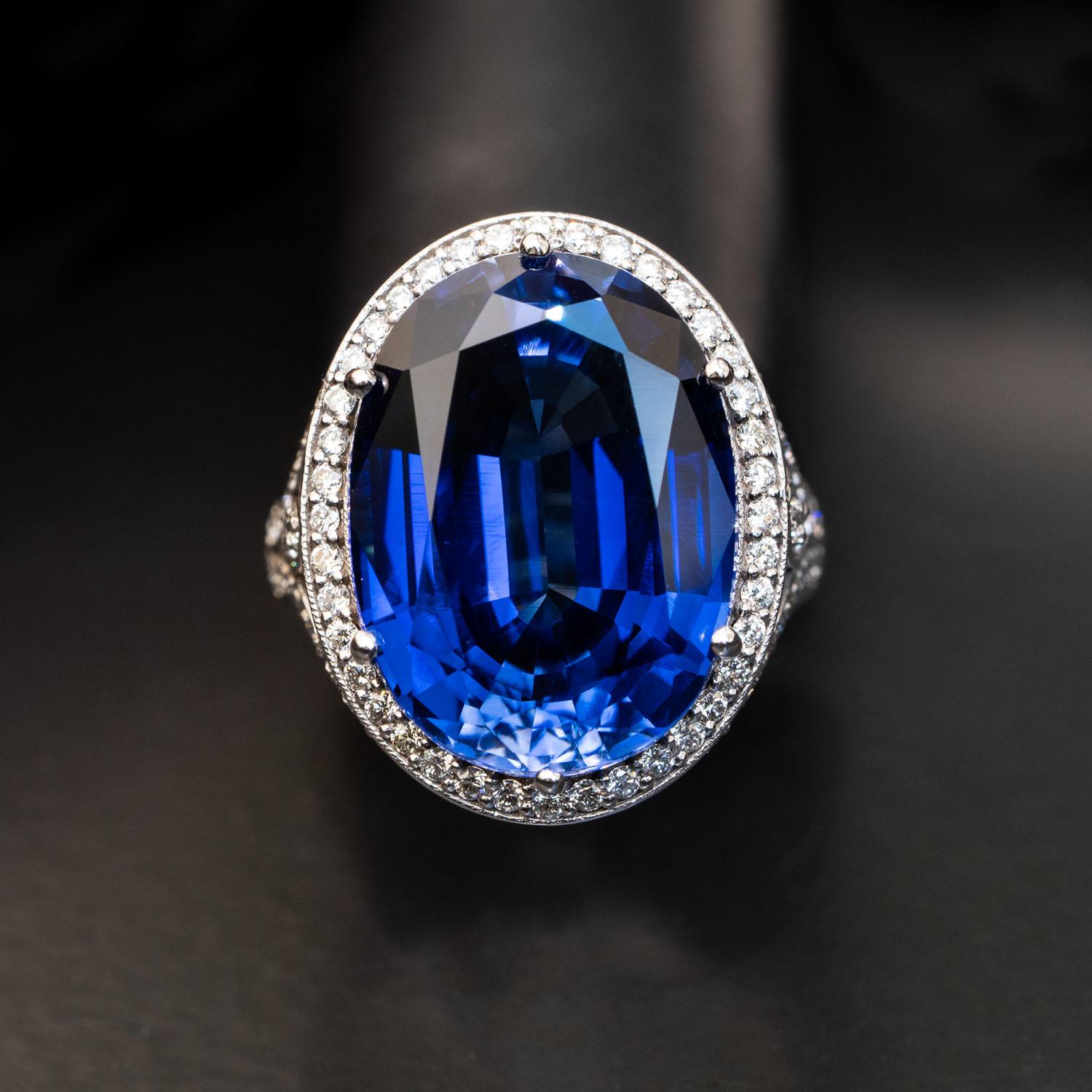 This gorgeous sapphire ring’s center gemstone may command attention initially, but it’s the regal details along the edges and shank that invite the eyes to linger.

The 26 carat deep blue sapphire in the heart of the design is ringed with a delicate