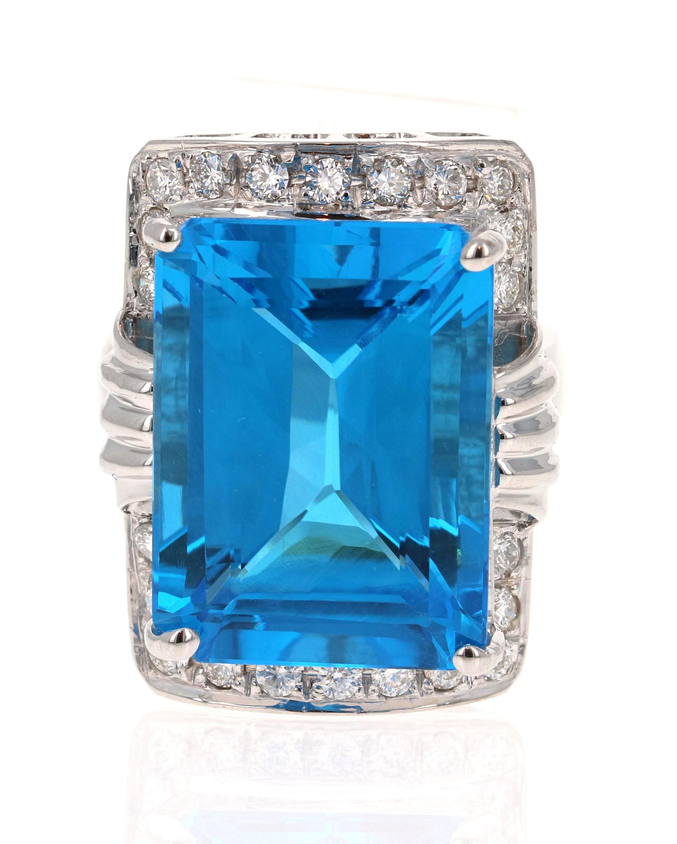 A true statement piece! 
This stunning ring has a huge Emerald Cut Blue Topaz that weighs 25.31 carats and is surrounded by 22 Round Cut Diamonds that weigh 0.76 carat (Clarity: SI, Color: F). The total carat weight of the ring is 26.07 carats.

The