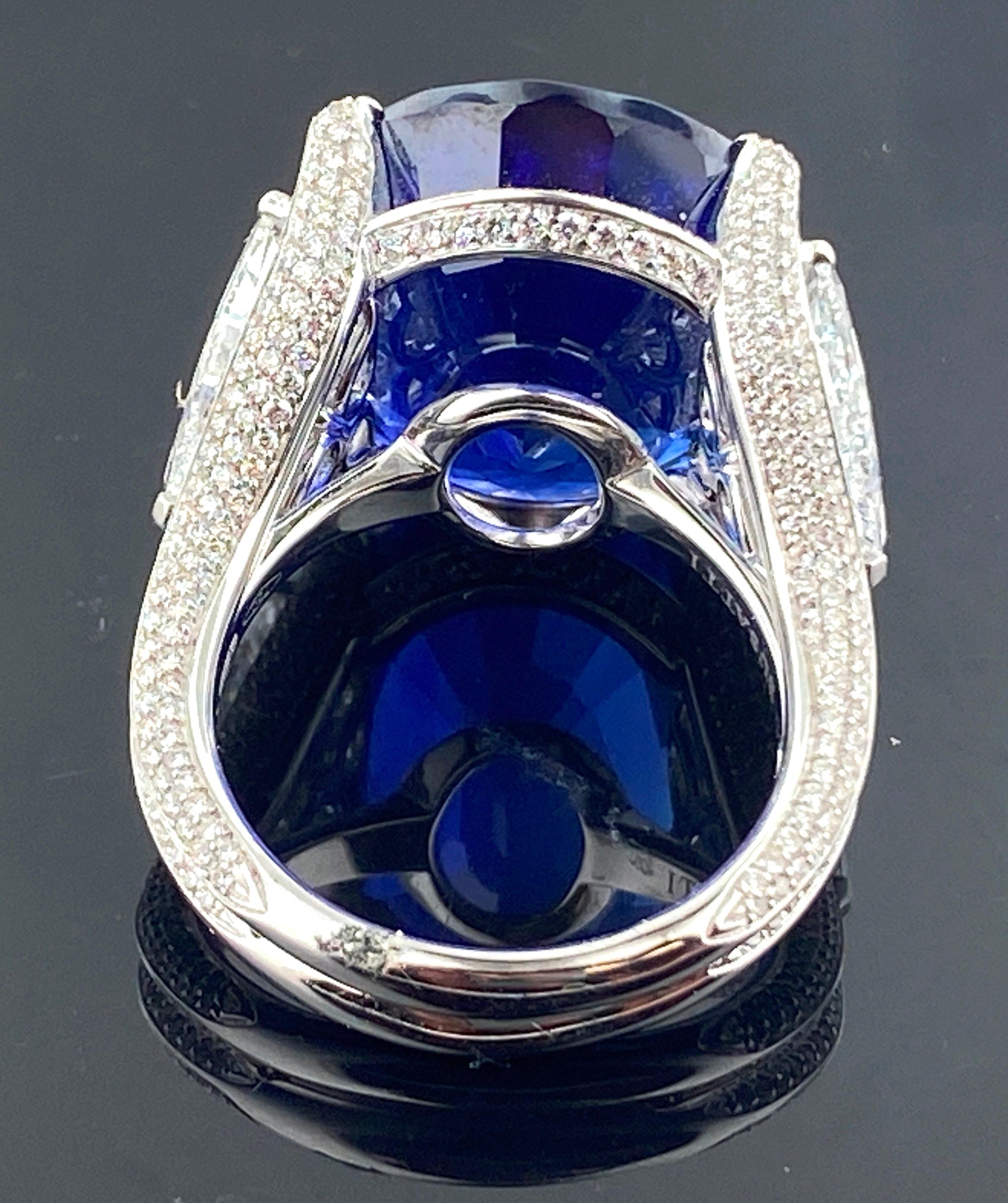 Oval Cut 26.08 Carat Oval Shaped Blue Sapphire with 2 GIA Side Trillion Diamonds For Sale