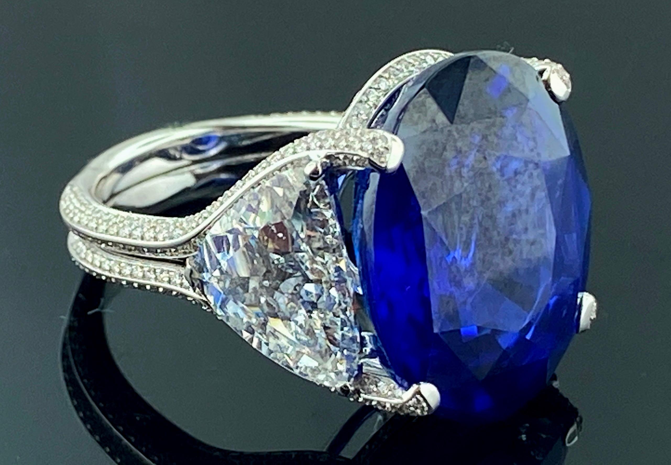 Women's or Men's 26.08 Carat Oval Shaped Blue Sapphire with 2 GIA Side Trillion Diamonds For Sale