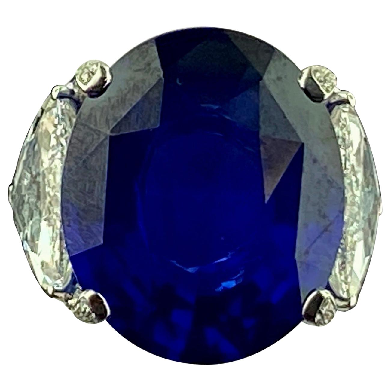 26.08 Carat Oval Shaped Blue Sapphire with 2 GIA Side Trillion Diamonds For Sale